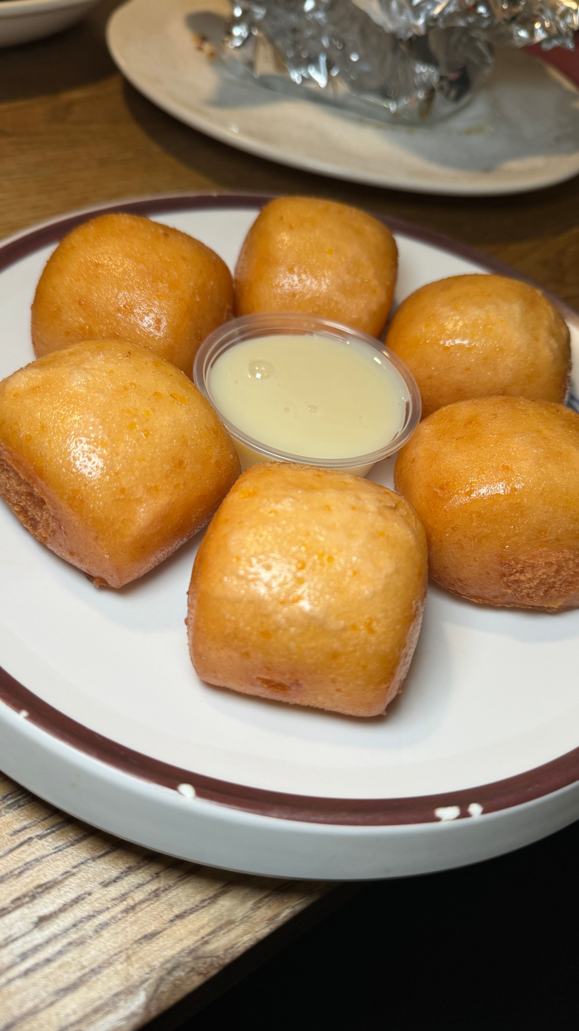 A plate of food with a dipping sauce on a table.