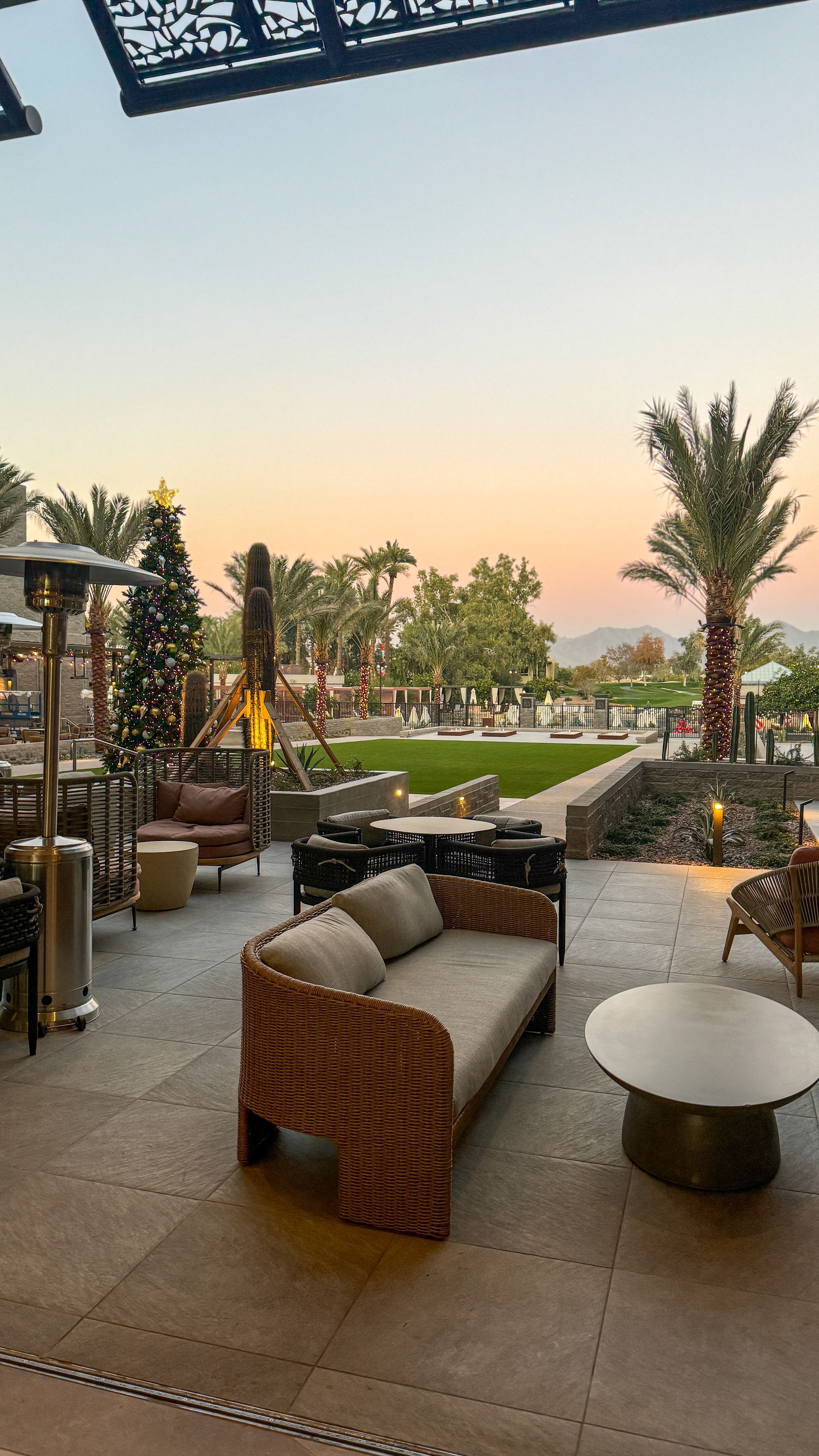 A patio with a couch , chairs , and a table.