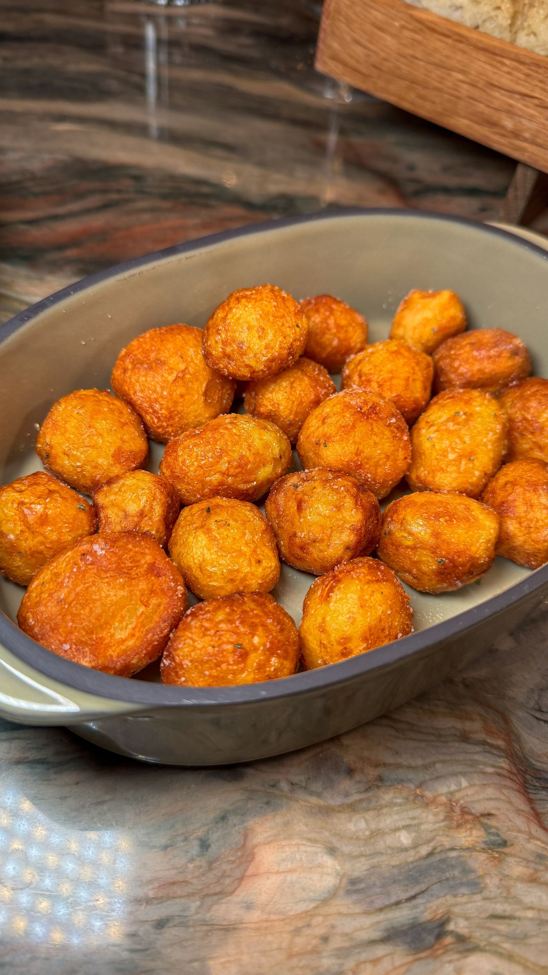 A casserole dish filled with fried food on a table.
