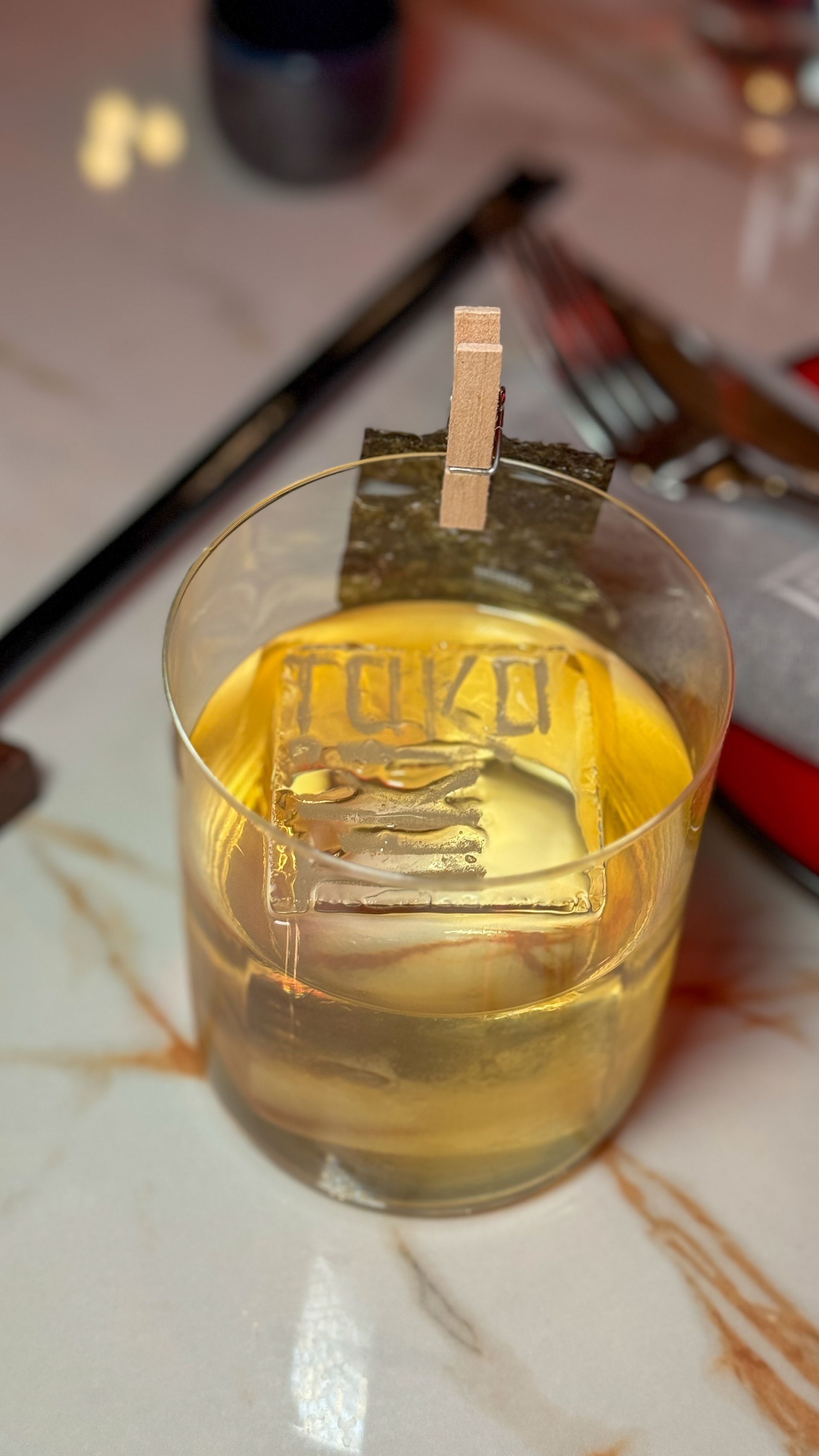 A close up of a glass of liquid on a table.