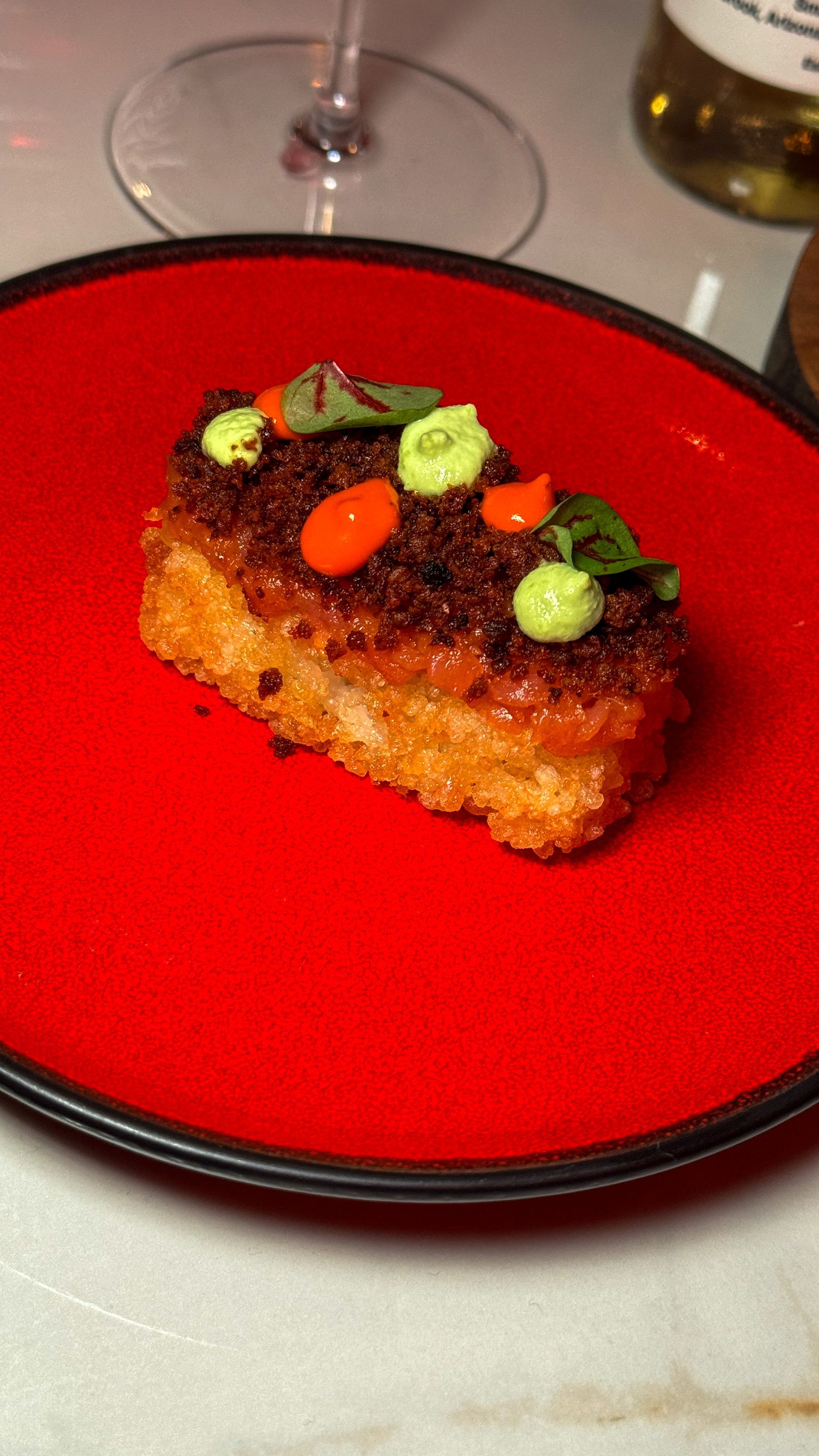 A red plate with a piece of food on it