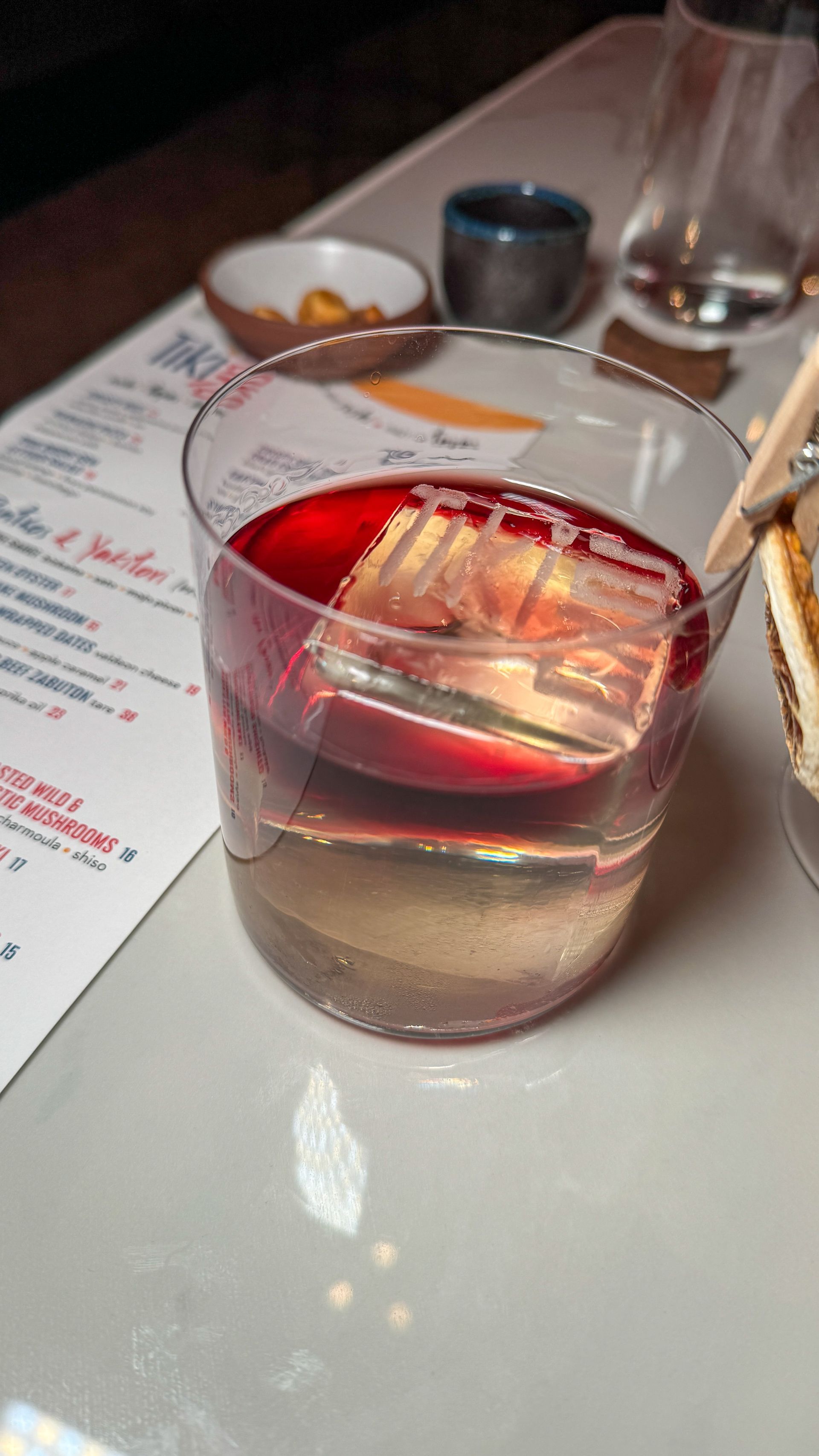 A close up of a glass of wine on a table.