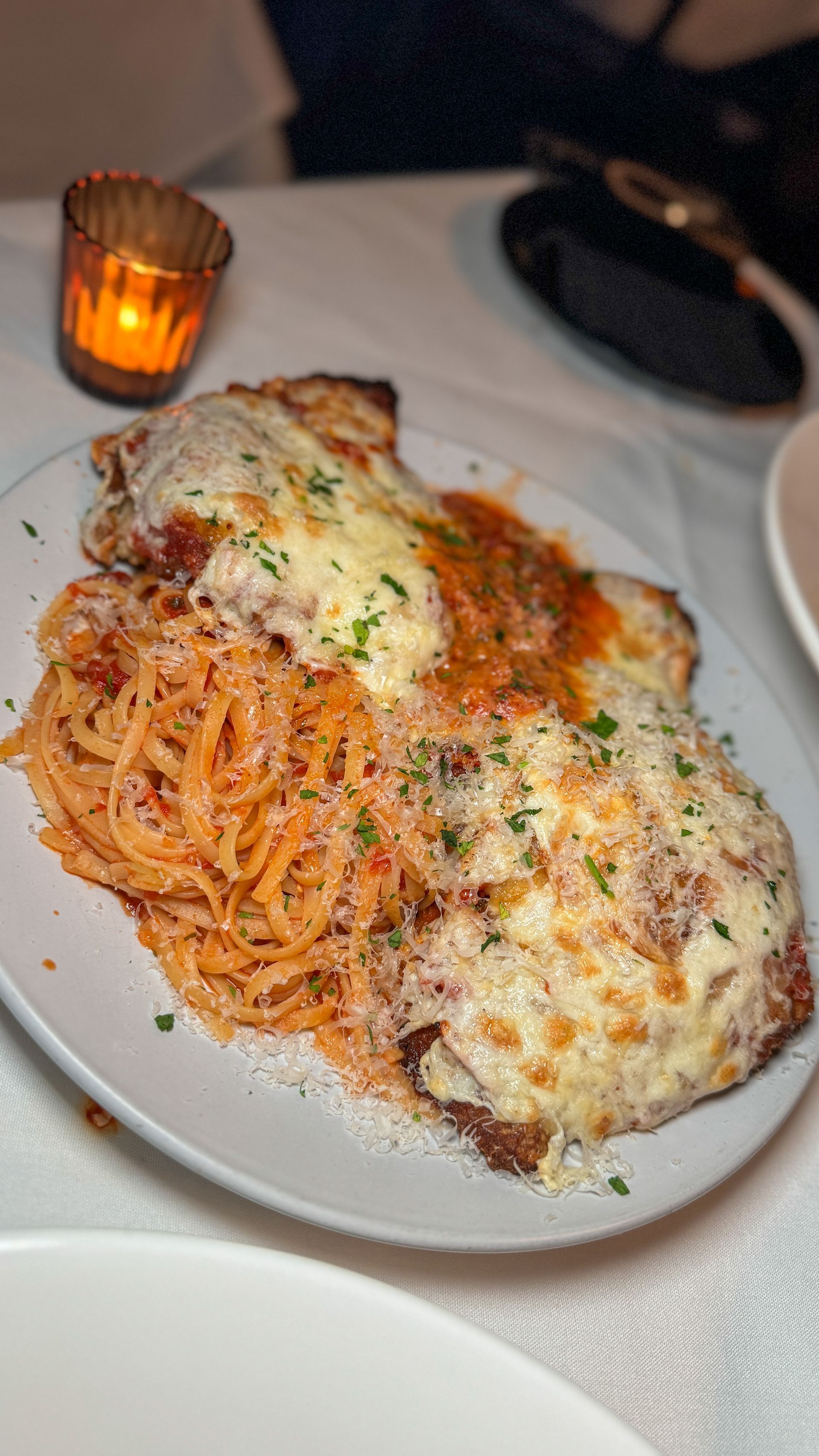 A plate of food with spaghetti and meat on a table.
