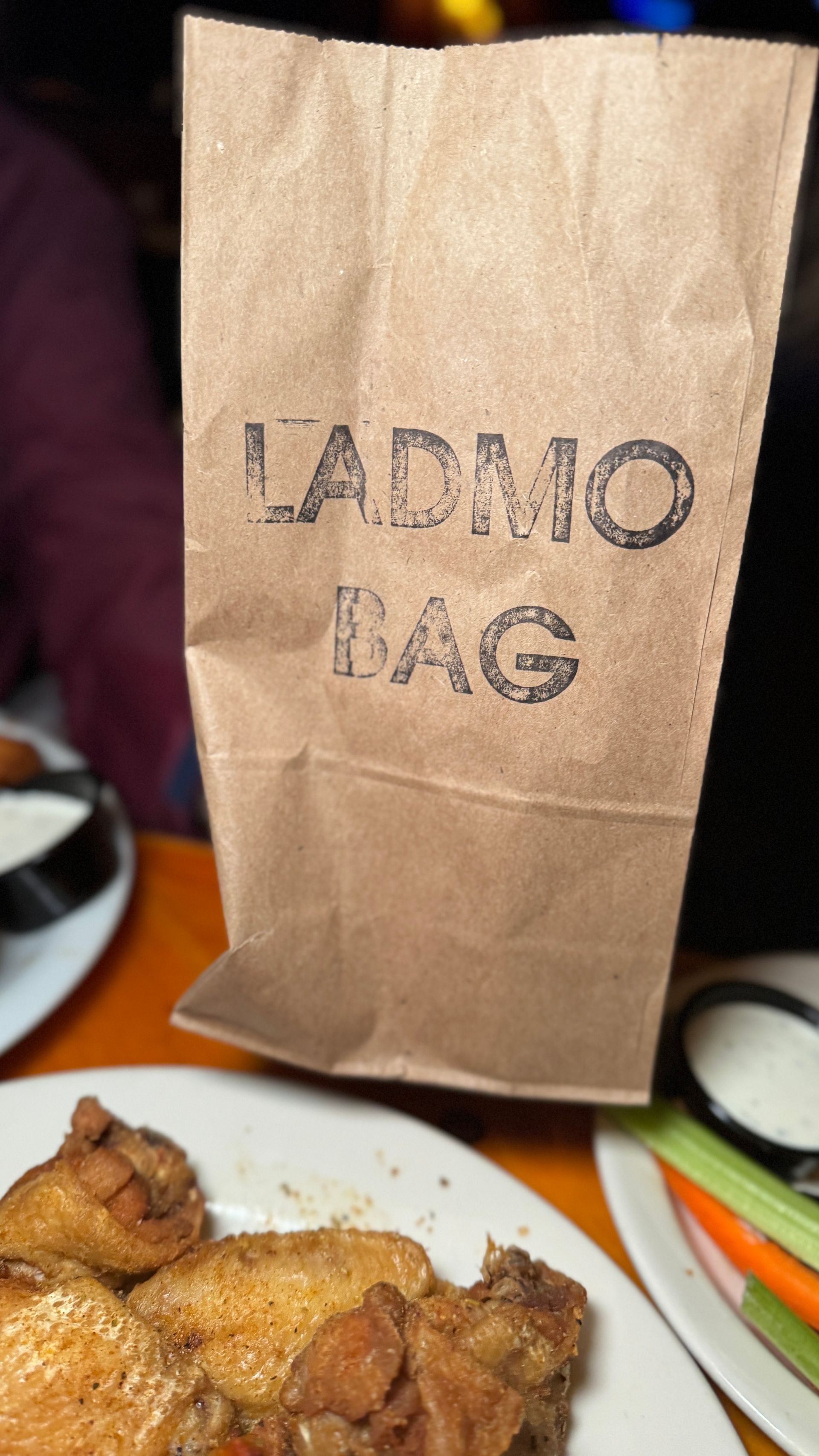 A brown paper bag that says madrid bag on it