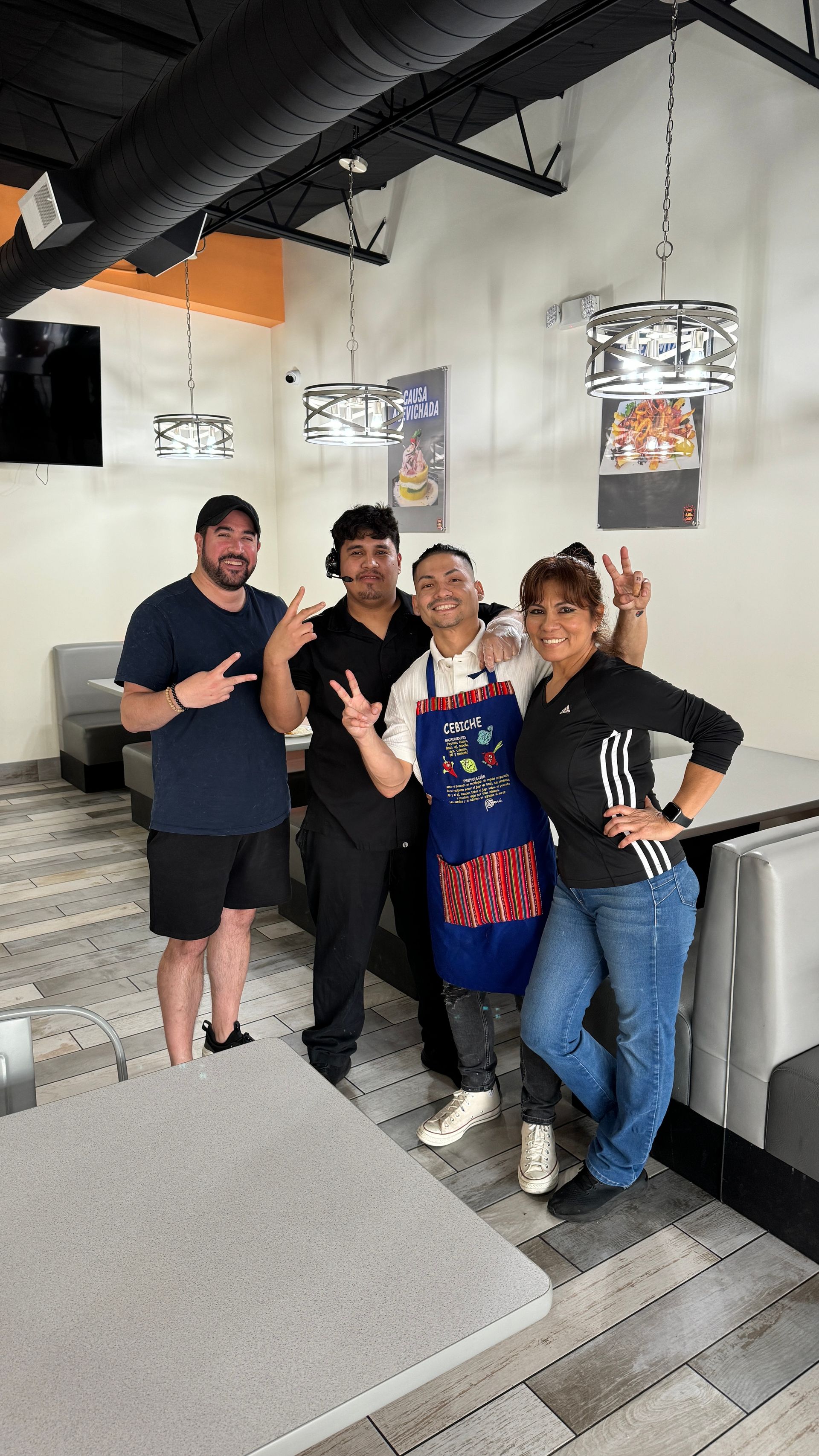 A group of people are posing for a picture in a restaurant.
