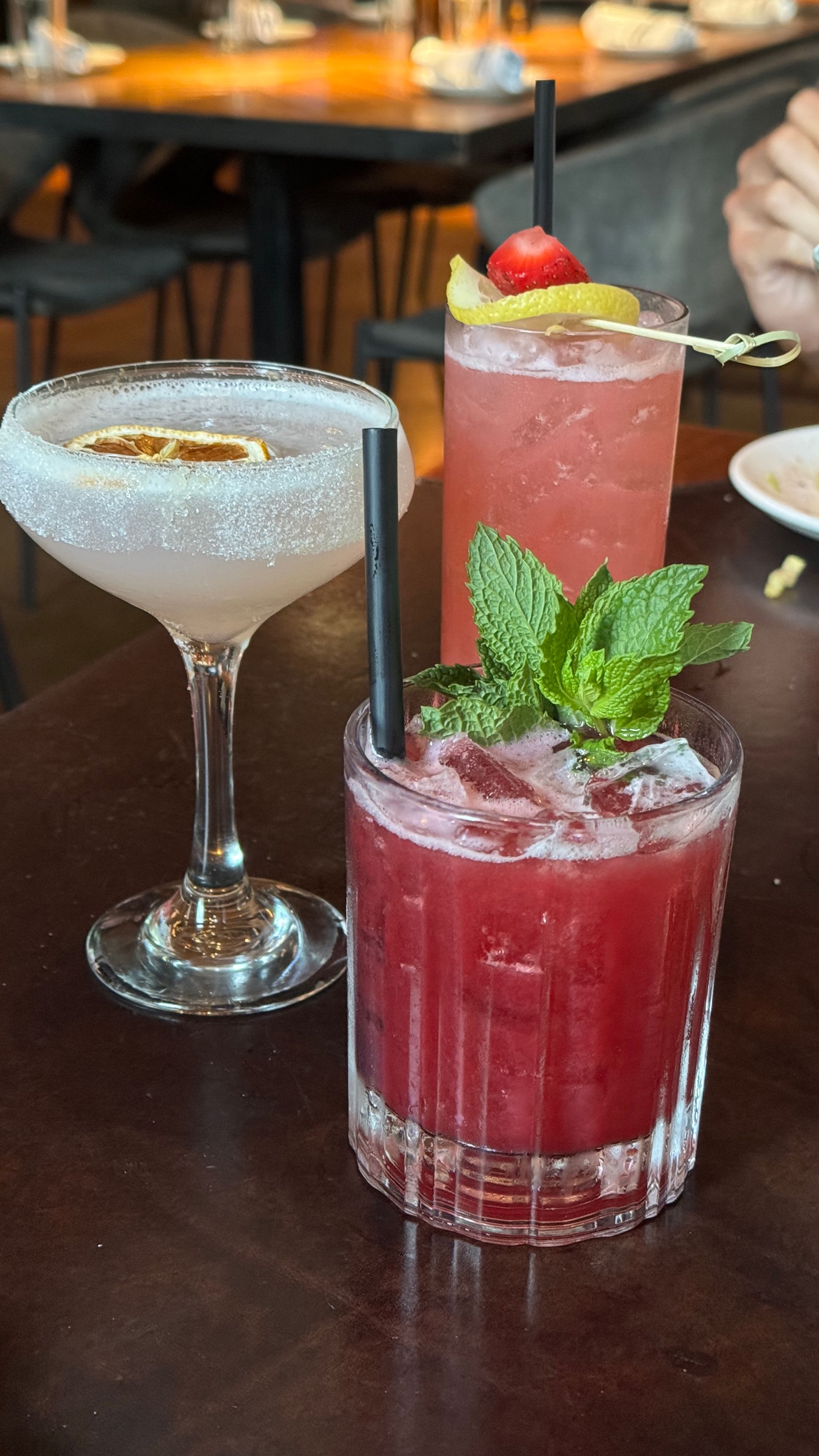Three different types of drinks are sitting on a table.