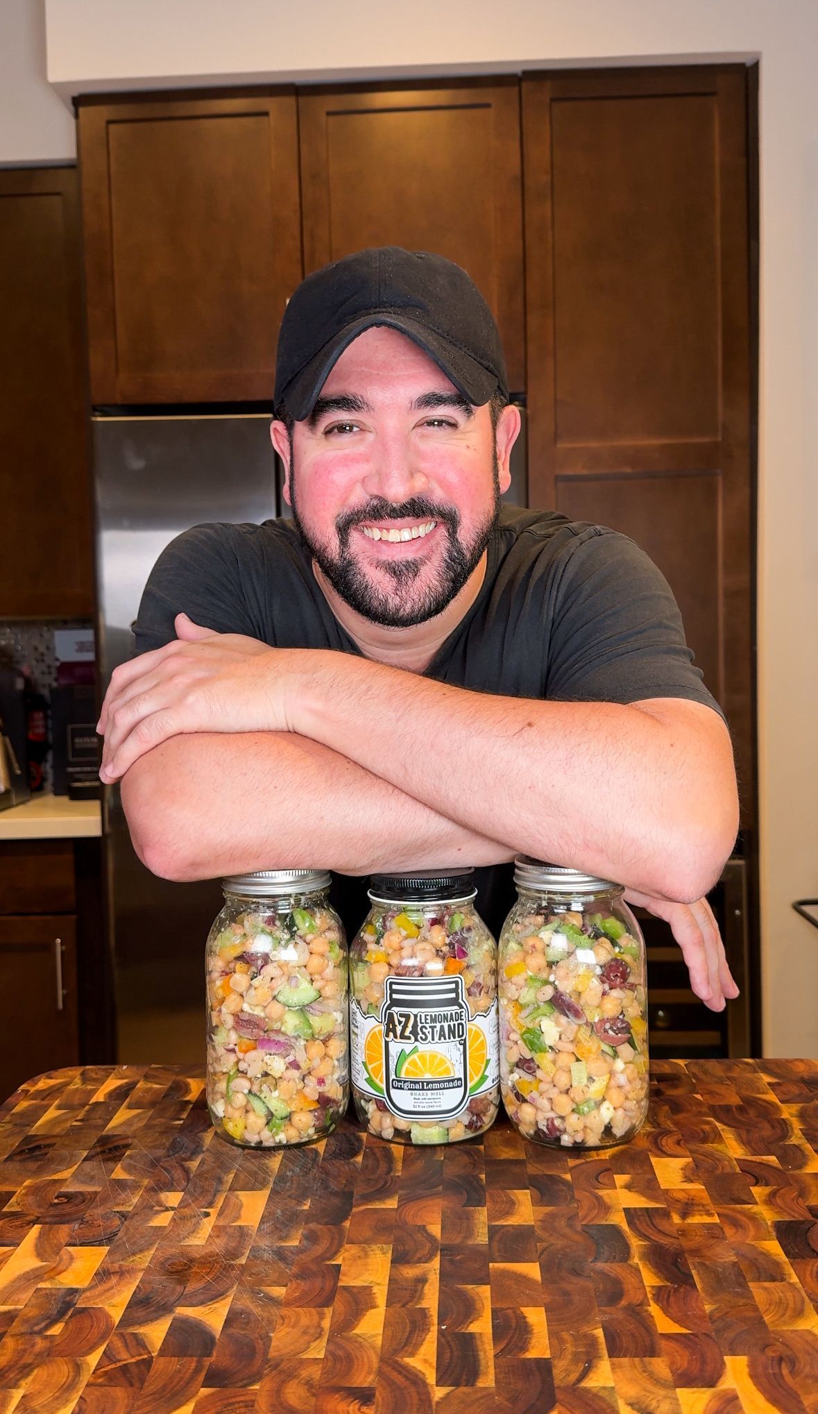 Pot of stew with carrots and meat, served in a black bowl.