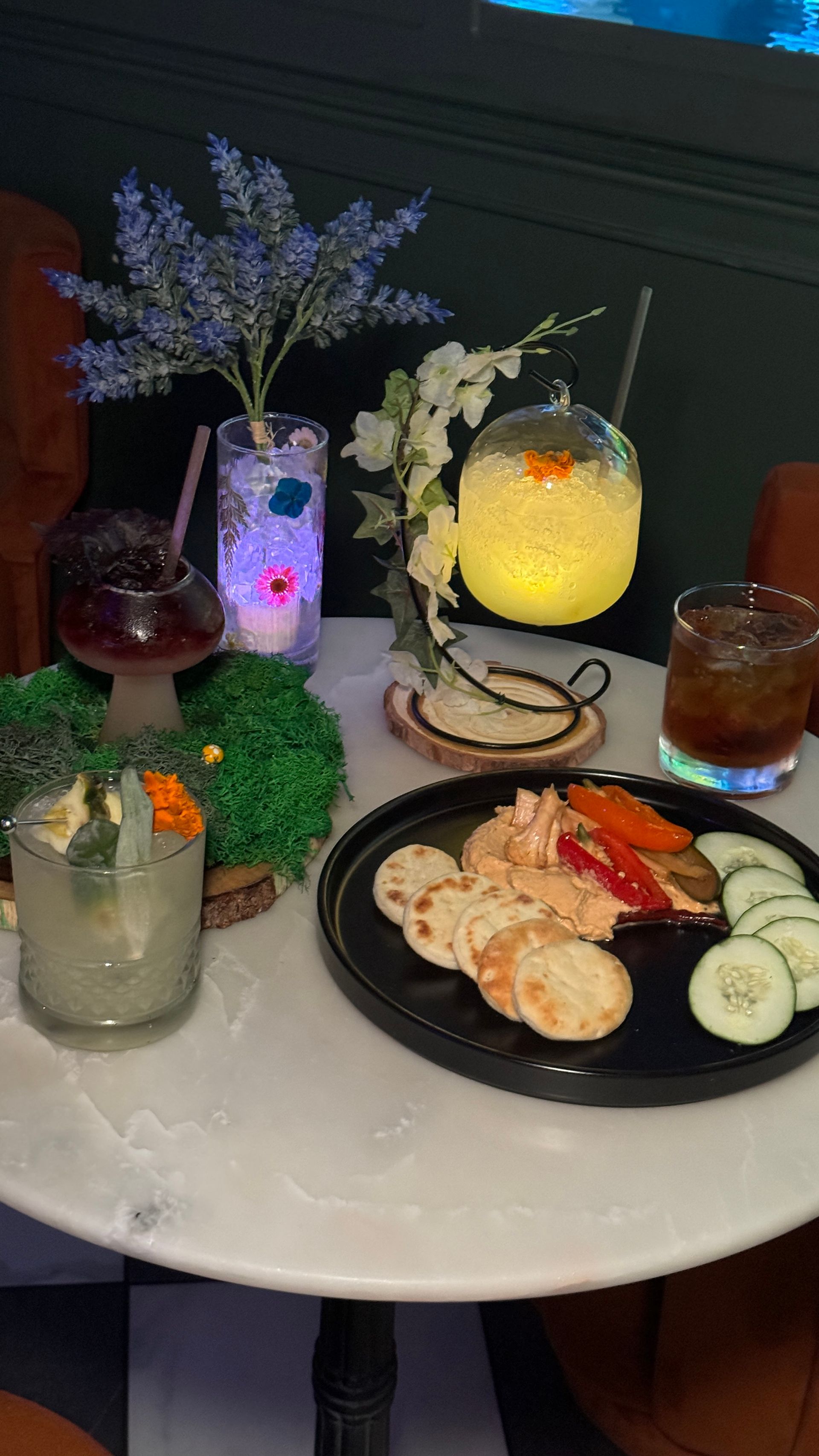 A table topped with plates of food and drinks.