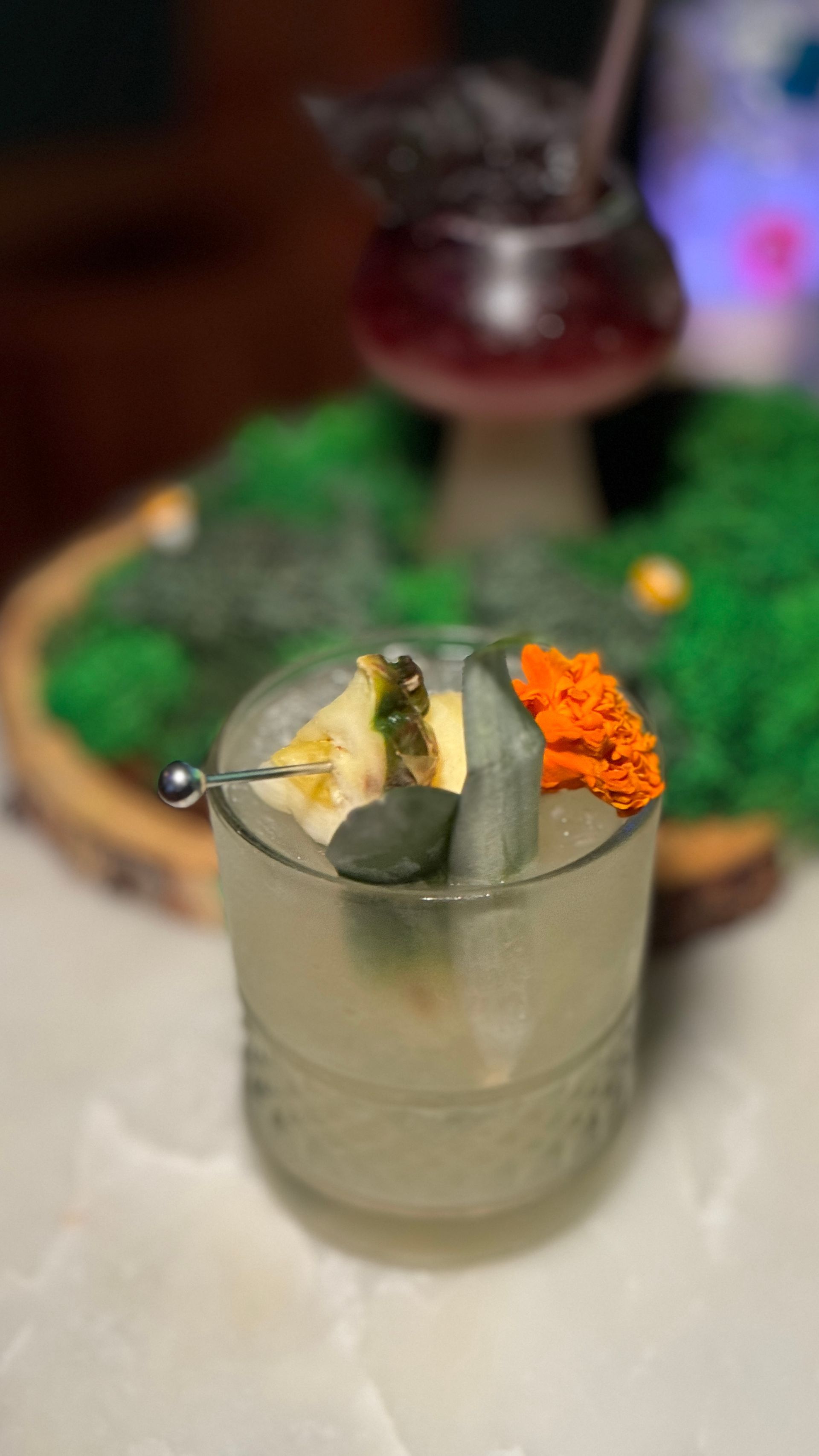 A close up of a drink in a glass on a table.