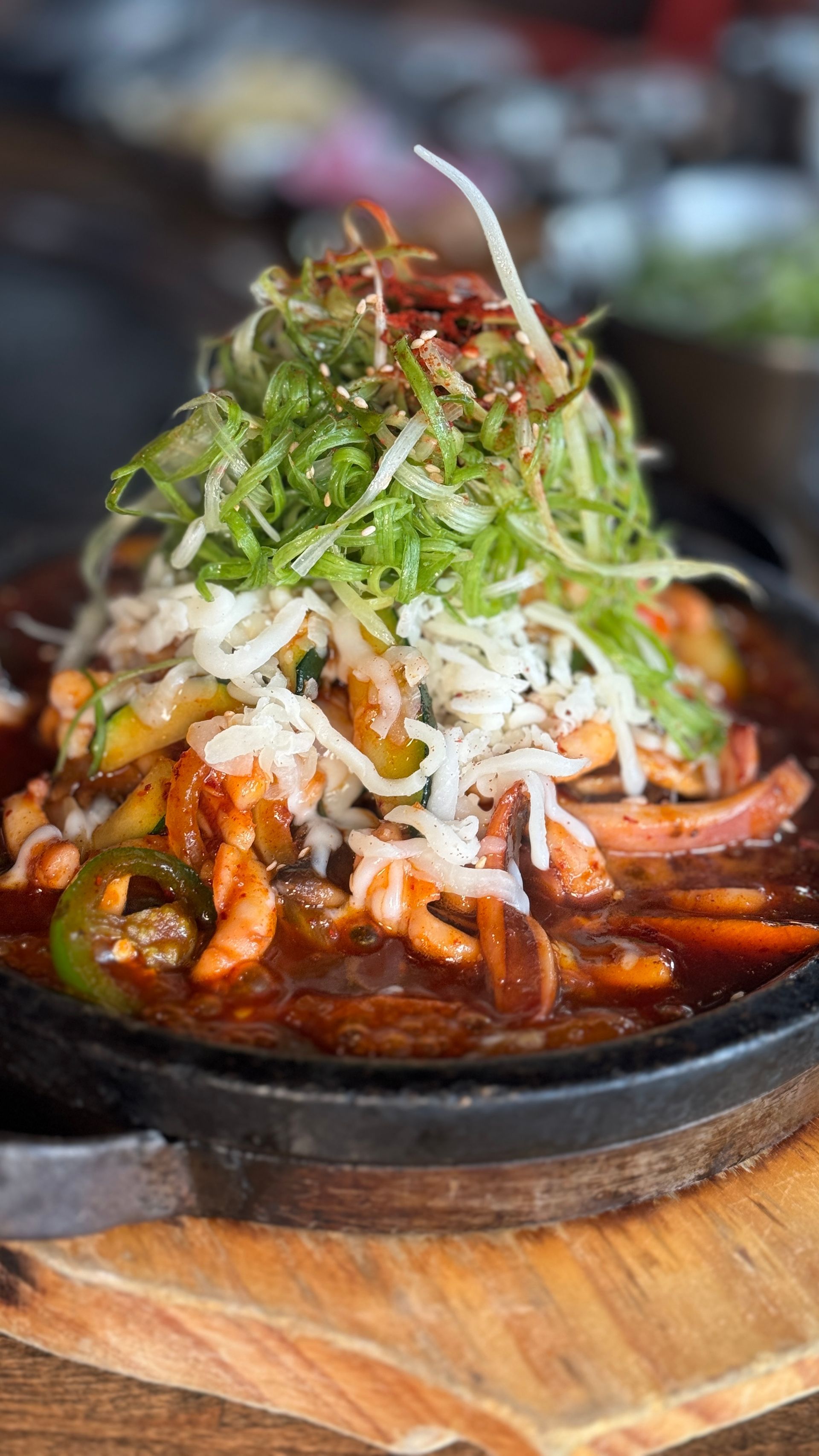 A close up of a plate of food on a wooden table.