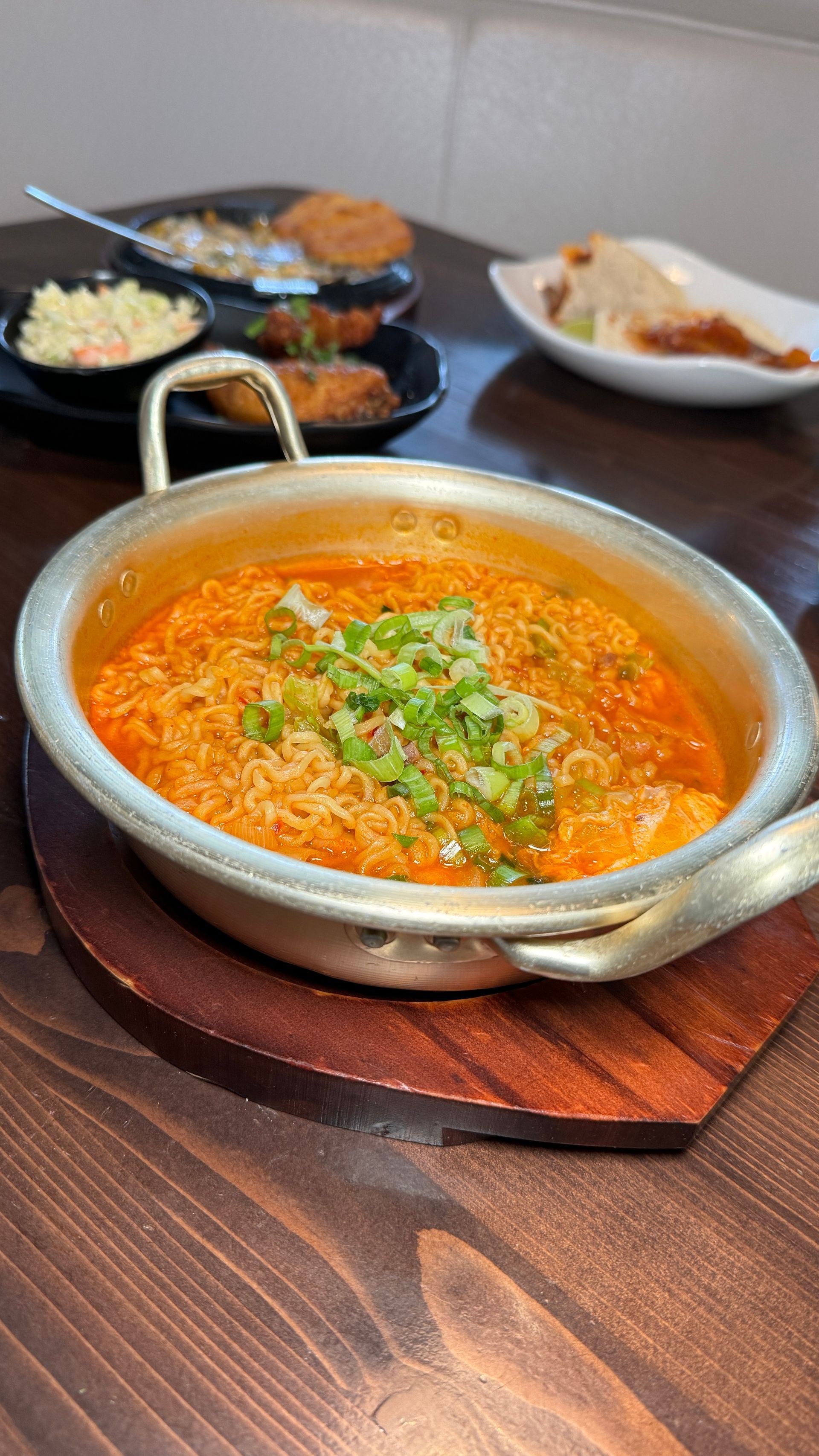 A bowl of food is sitting on a wooden table.