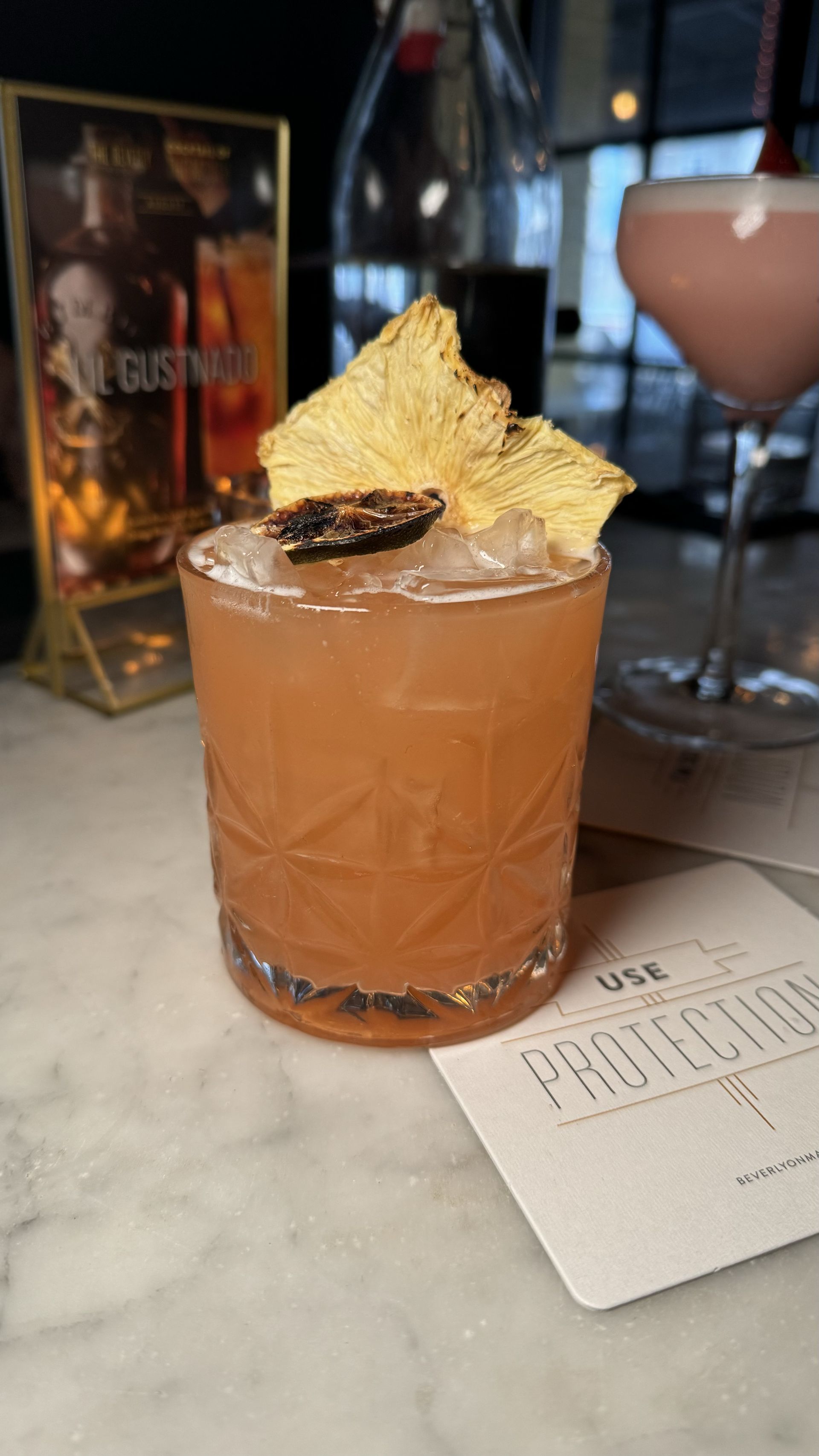 The Beverly - A close up of a drink in a glass on a table.