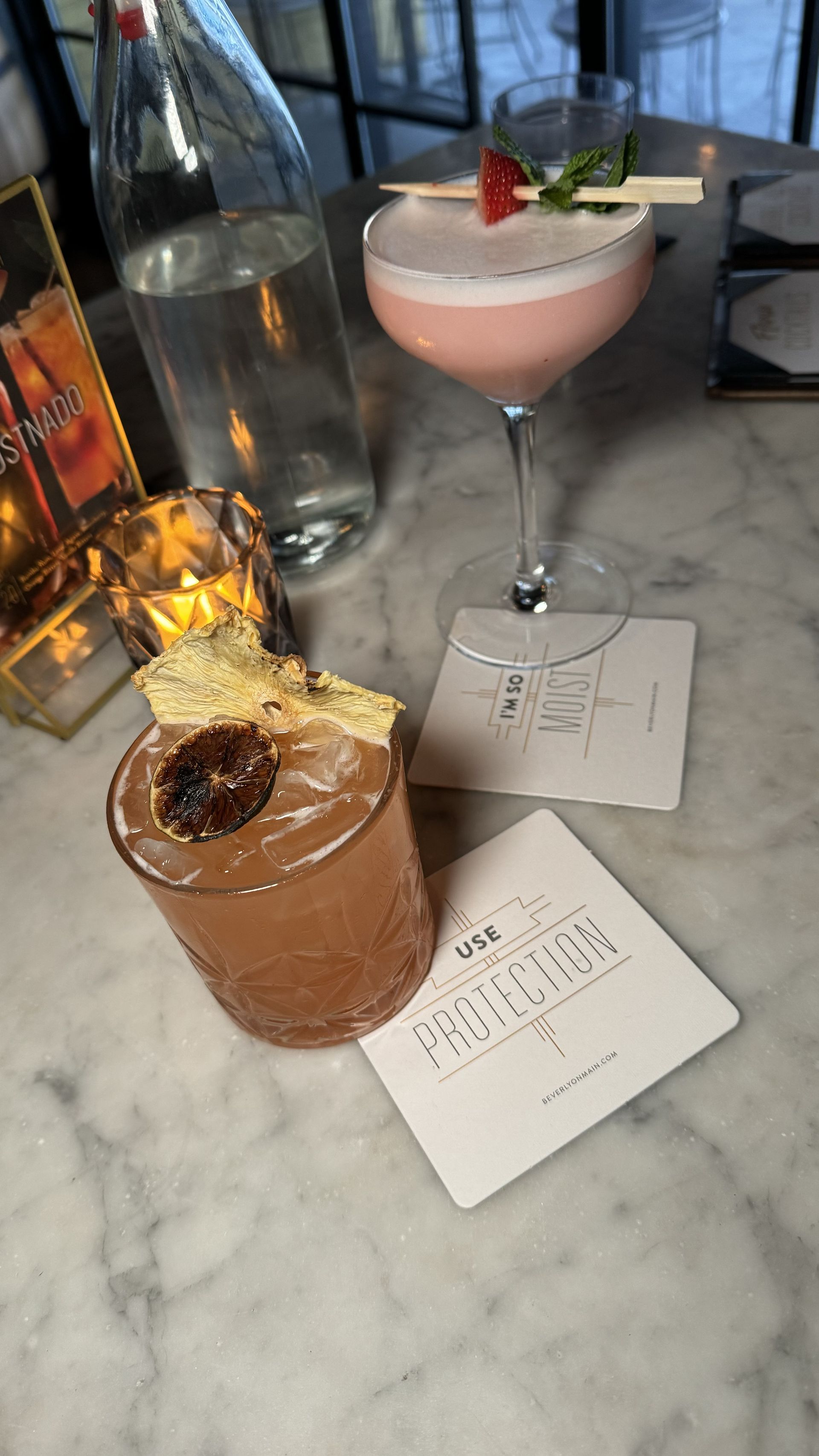 The Beverly - Two cocktails are sitting on a table next to each other.