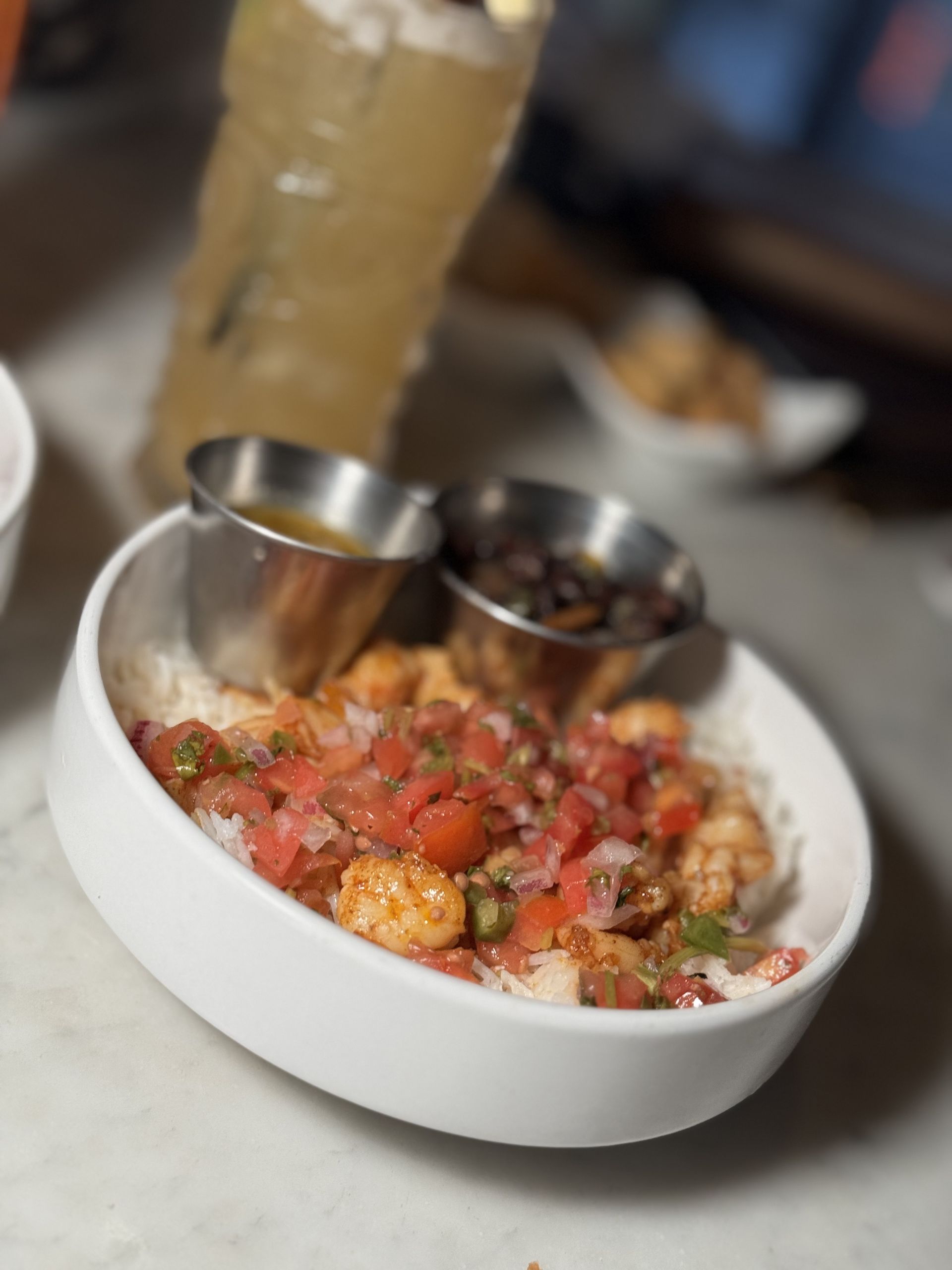 The Beverly - A bowl of food with shrimp and rice on a table