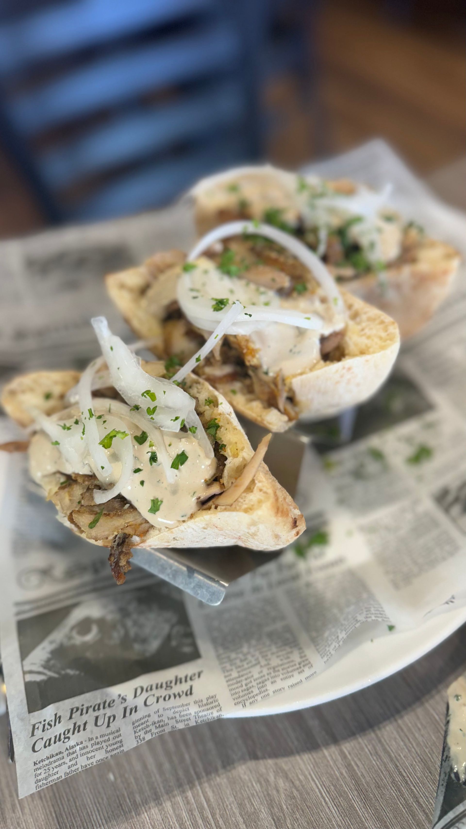 Fata Morgana - A plate of food is sitting on top of a newspaper on a table.