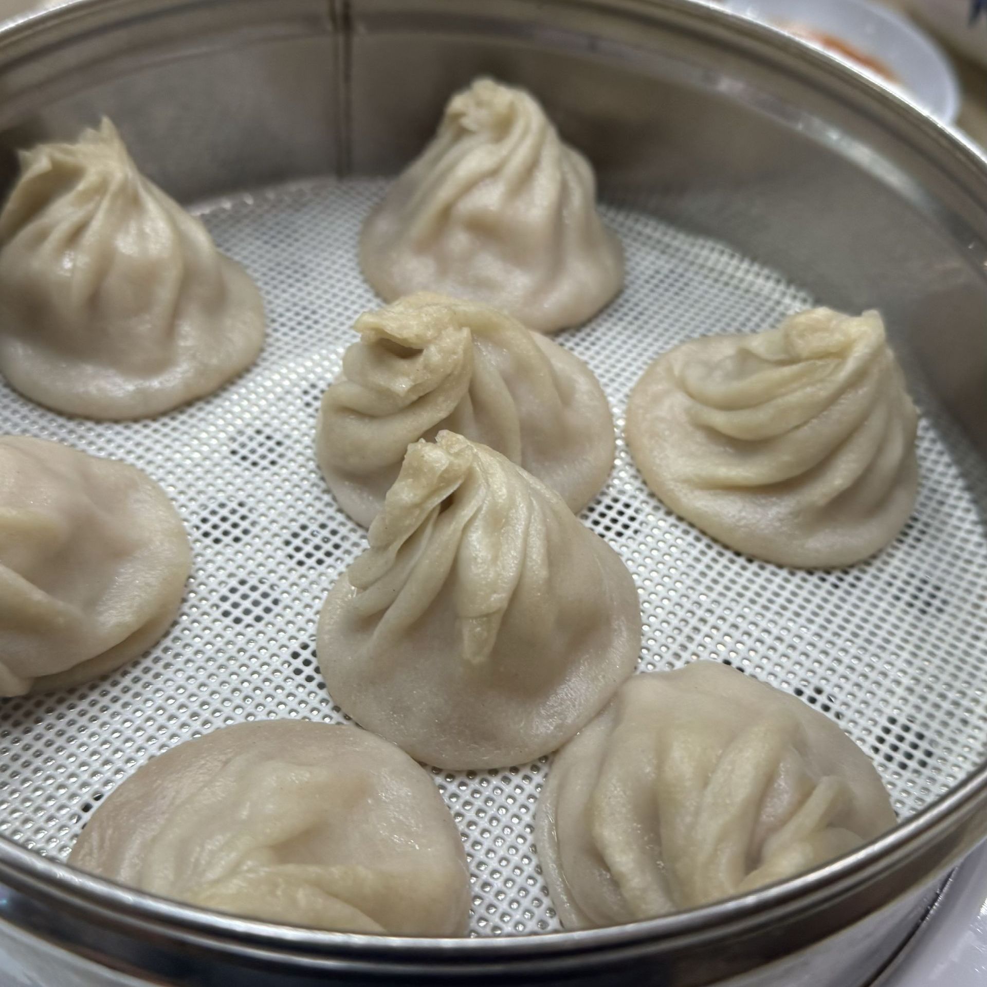 Happy Baos - A bunch of dumplings are sitting in a steamer