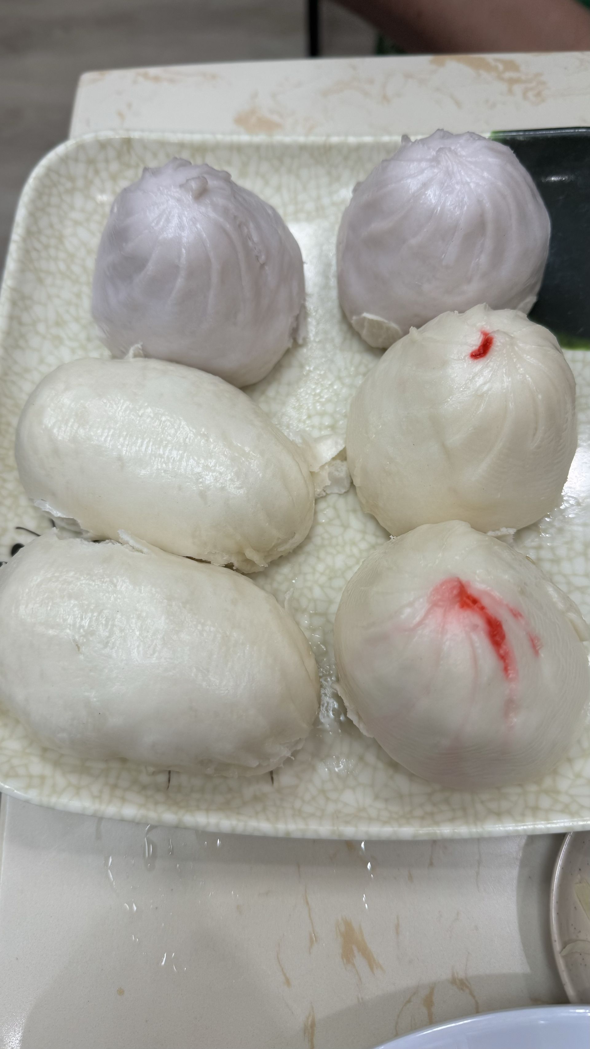 Happy Baos - There are many different types of dumplings on the plate.