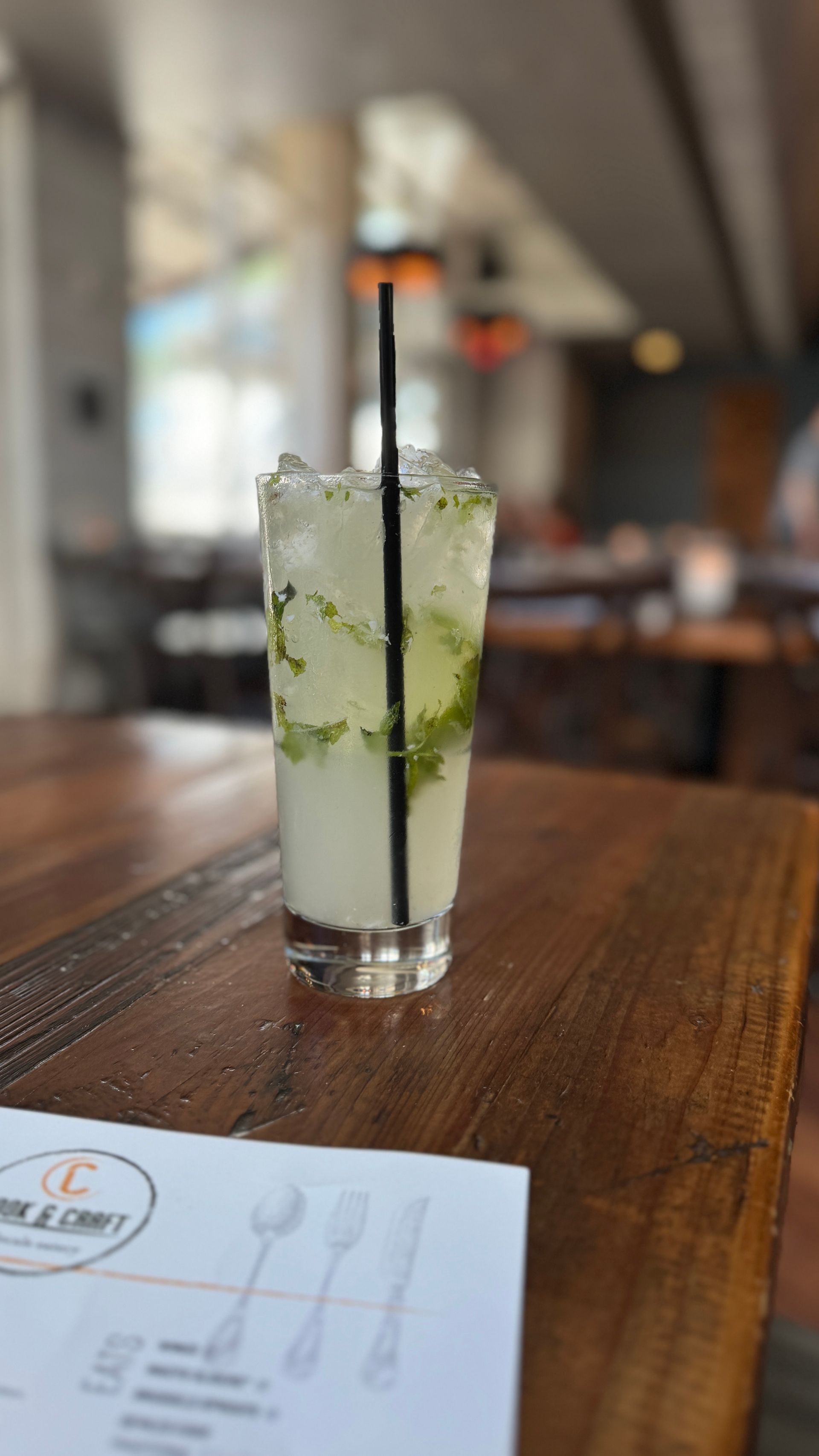 Cook & Craft - A drink with a straw is sitting on a wooden table.