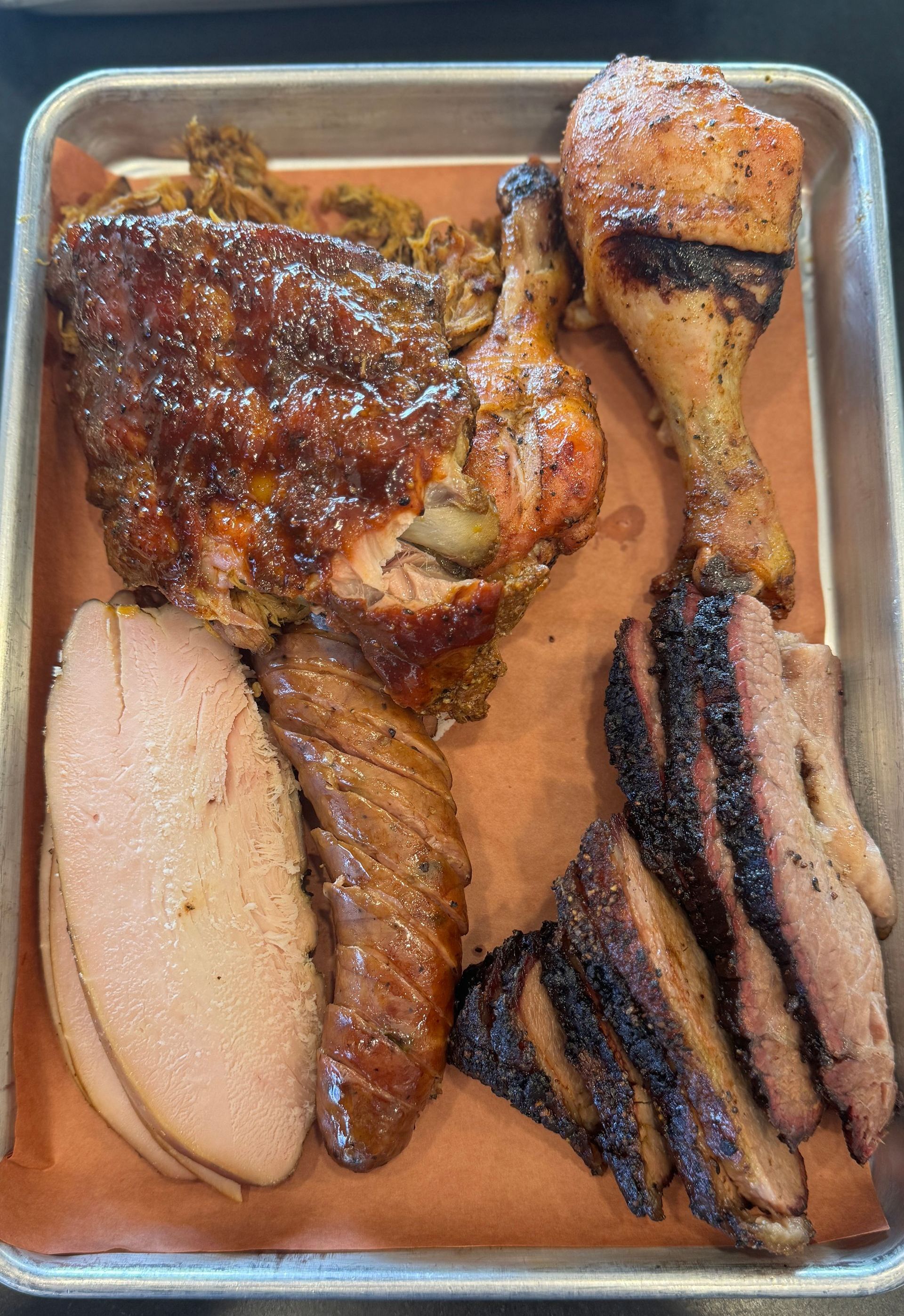 There are many different types of meat on the tray.