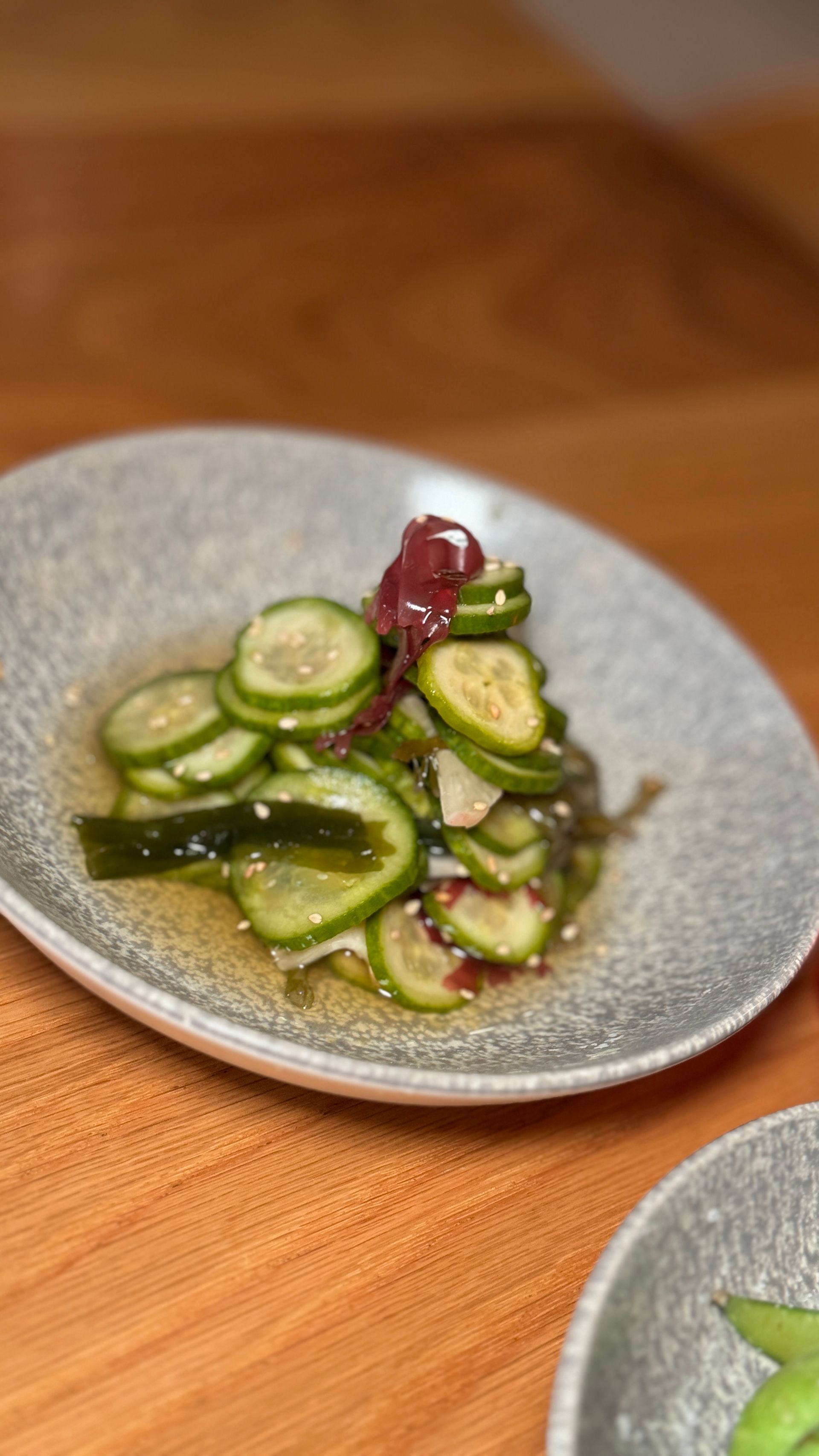 A close up of a plate of food on a wooden table.