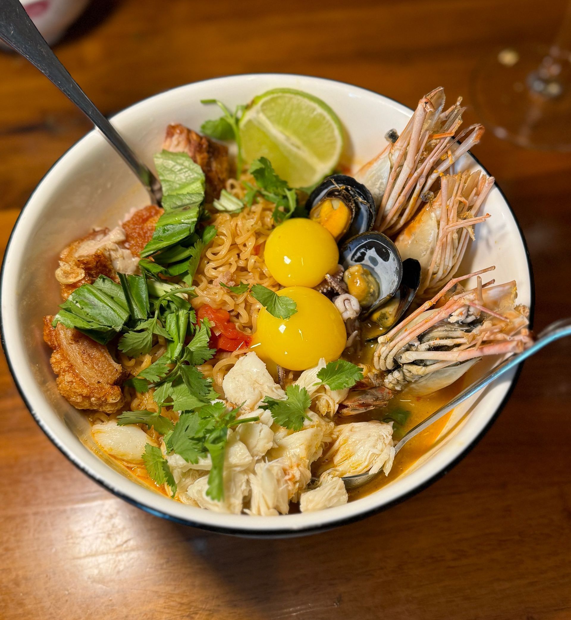 A bowl of food with a spoon in it on a table