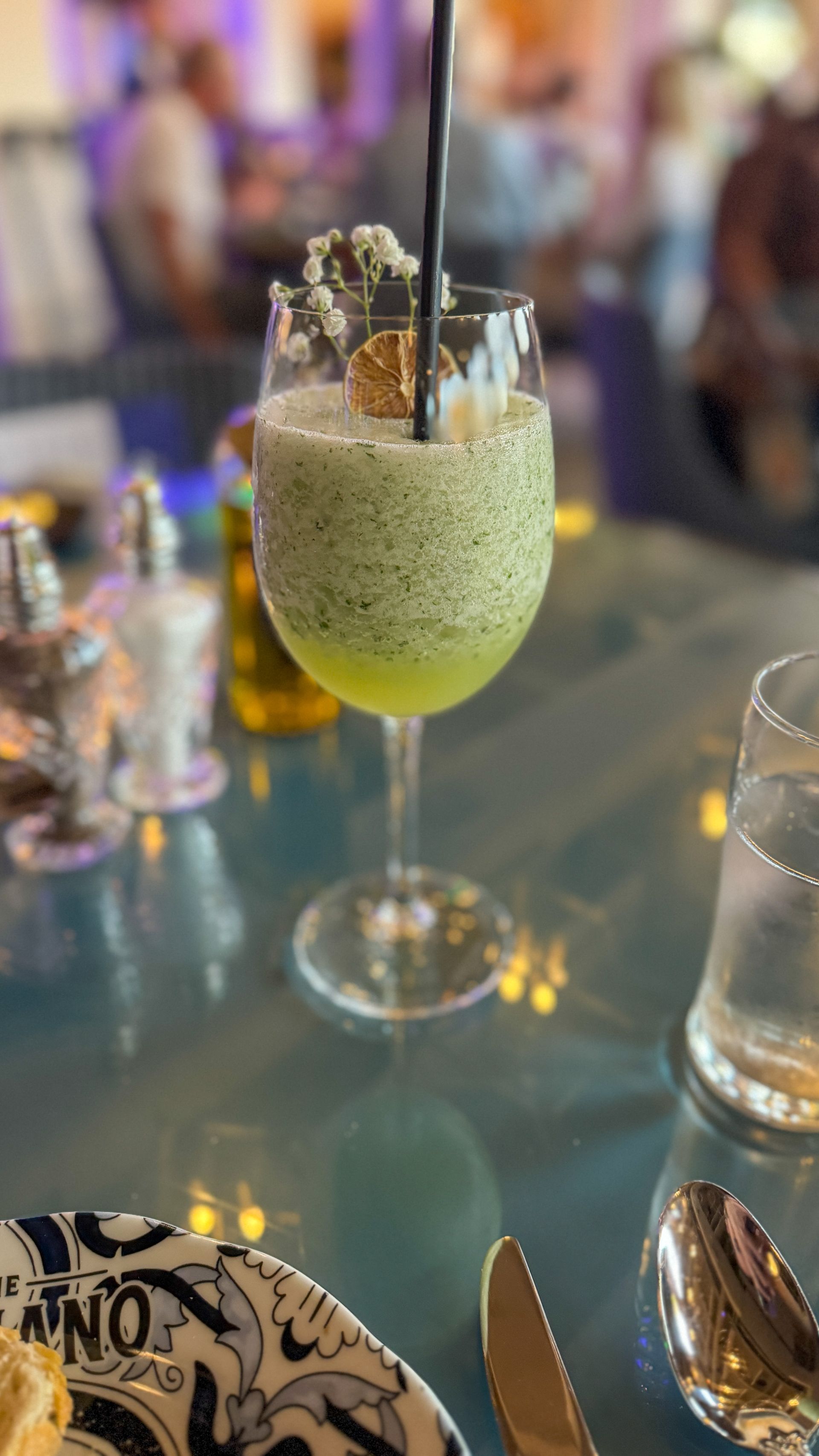 A close up of a drink in a glass on a table.
