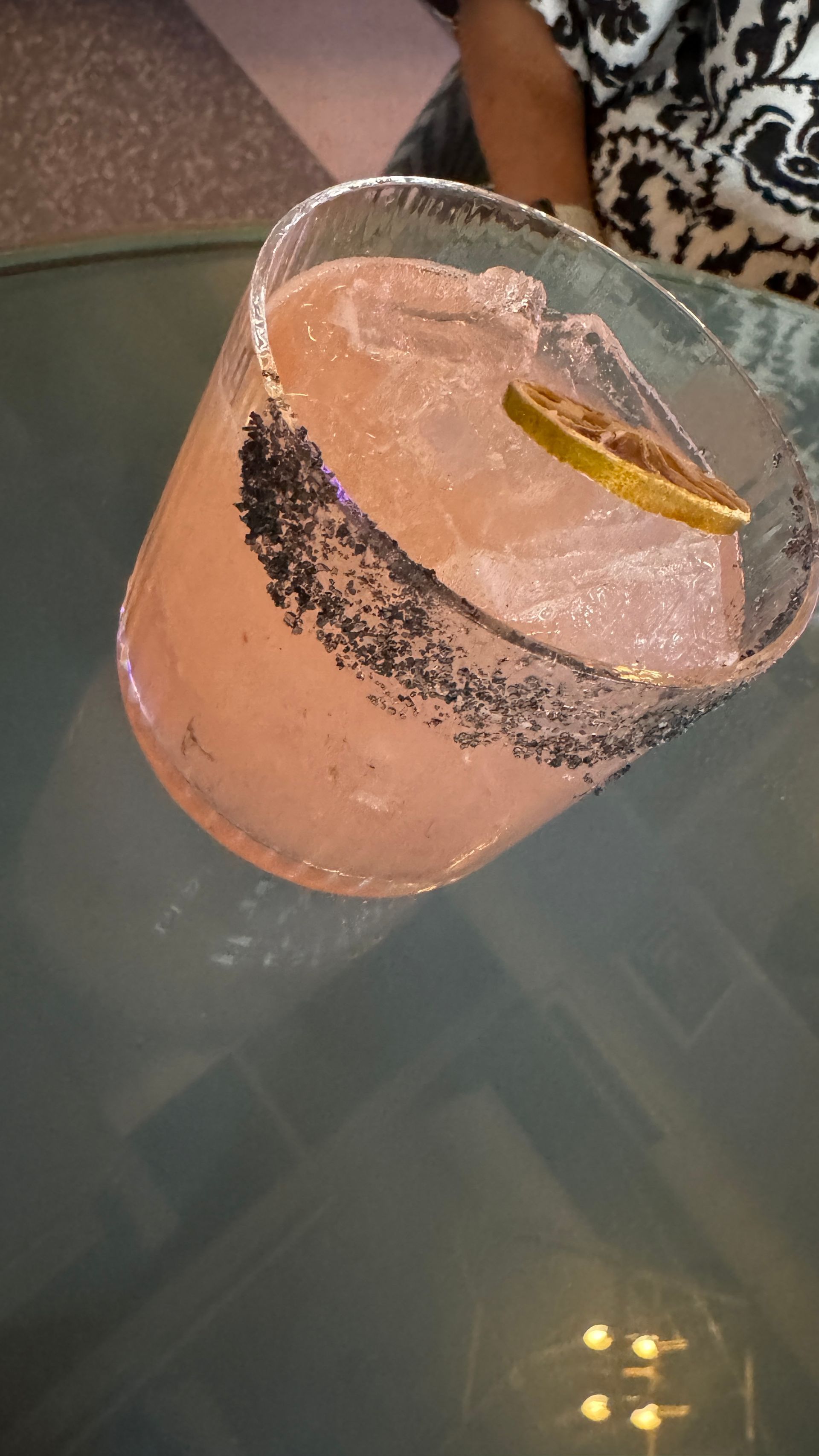 A close up of a drink in a glass on a table.