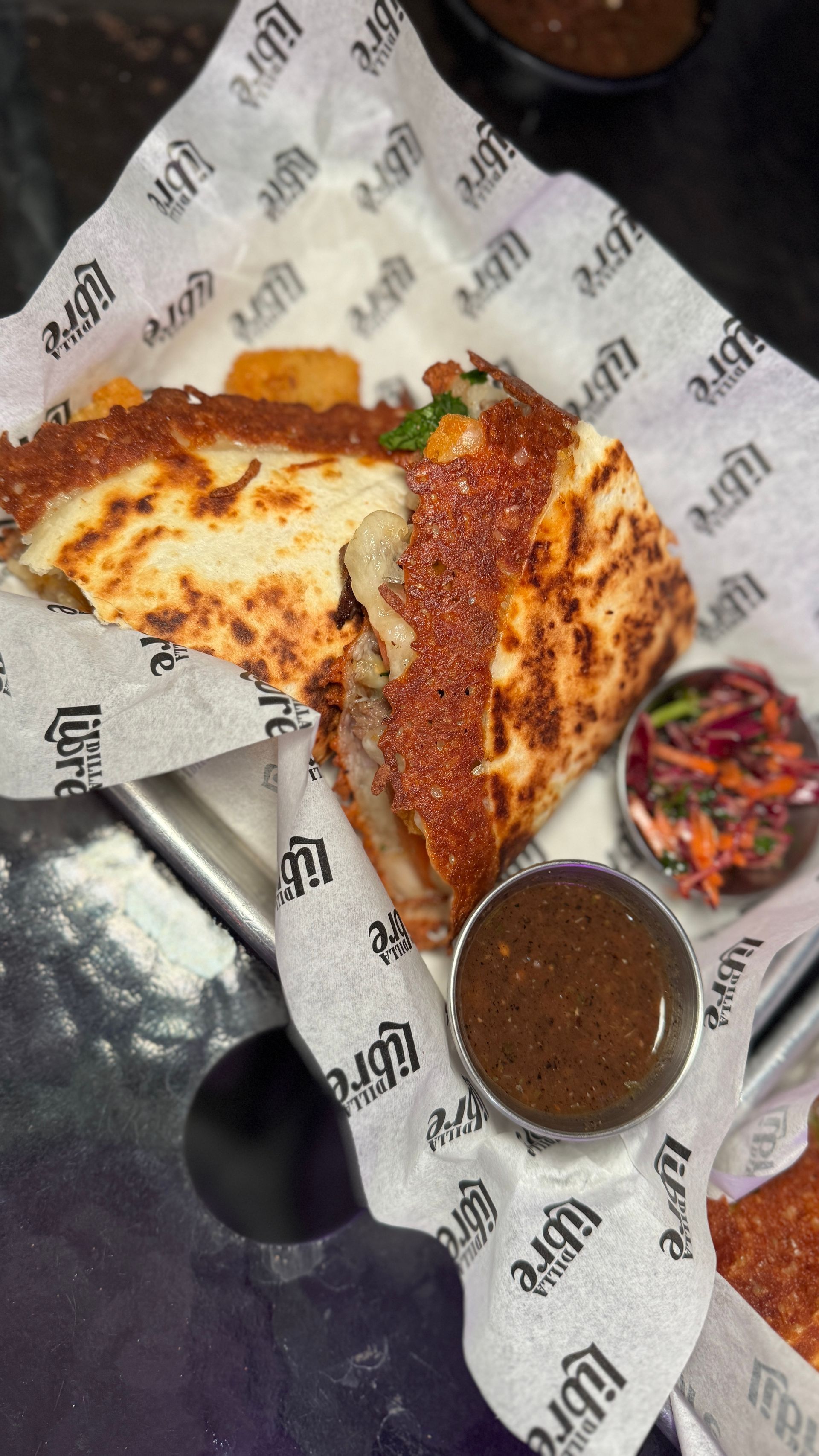 A close up of a sandwich on a plate with sauce.