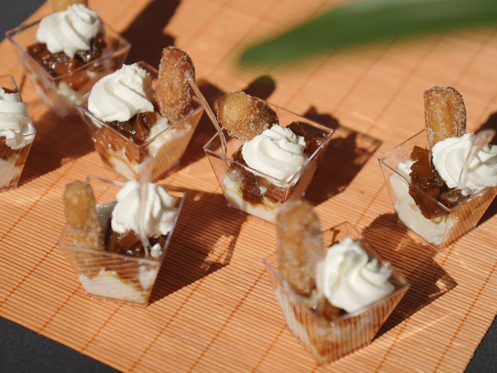 A tray of desserts with whipped cream and churros