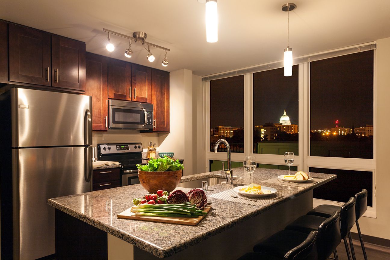 A kitchen with stainless steel appliances and granite counter tops