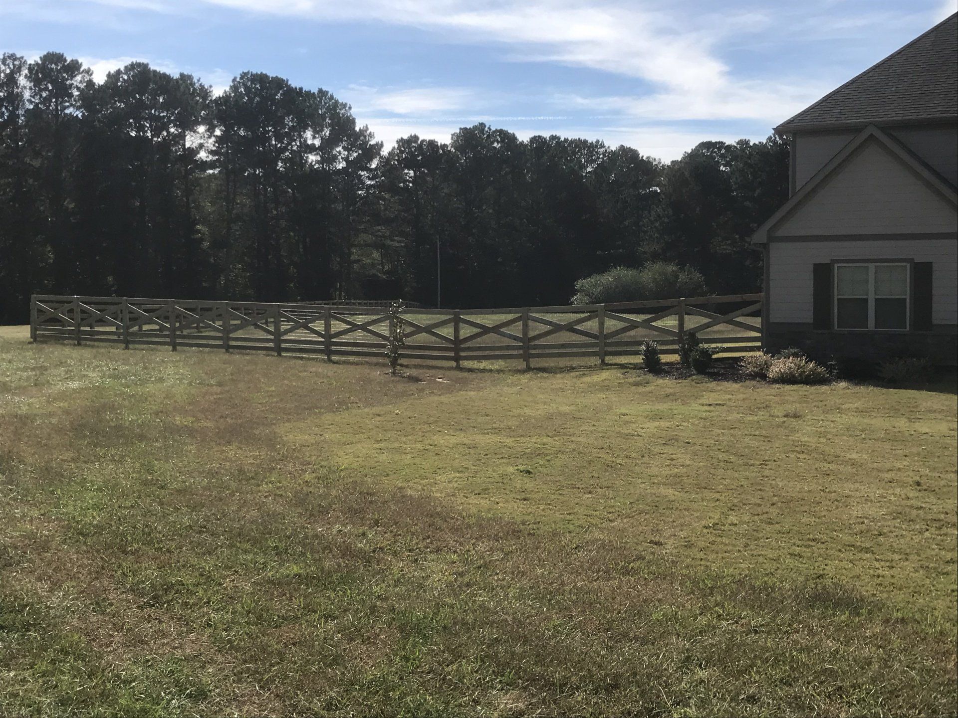 A house with a wooden fence in front of it