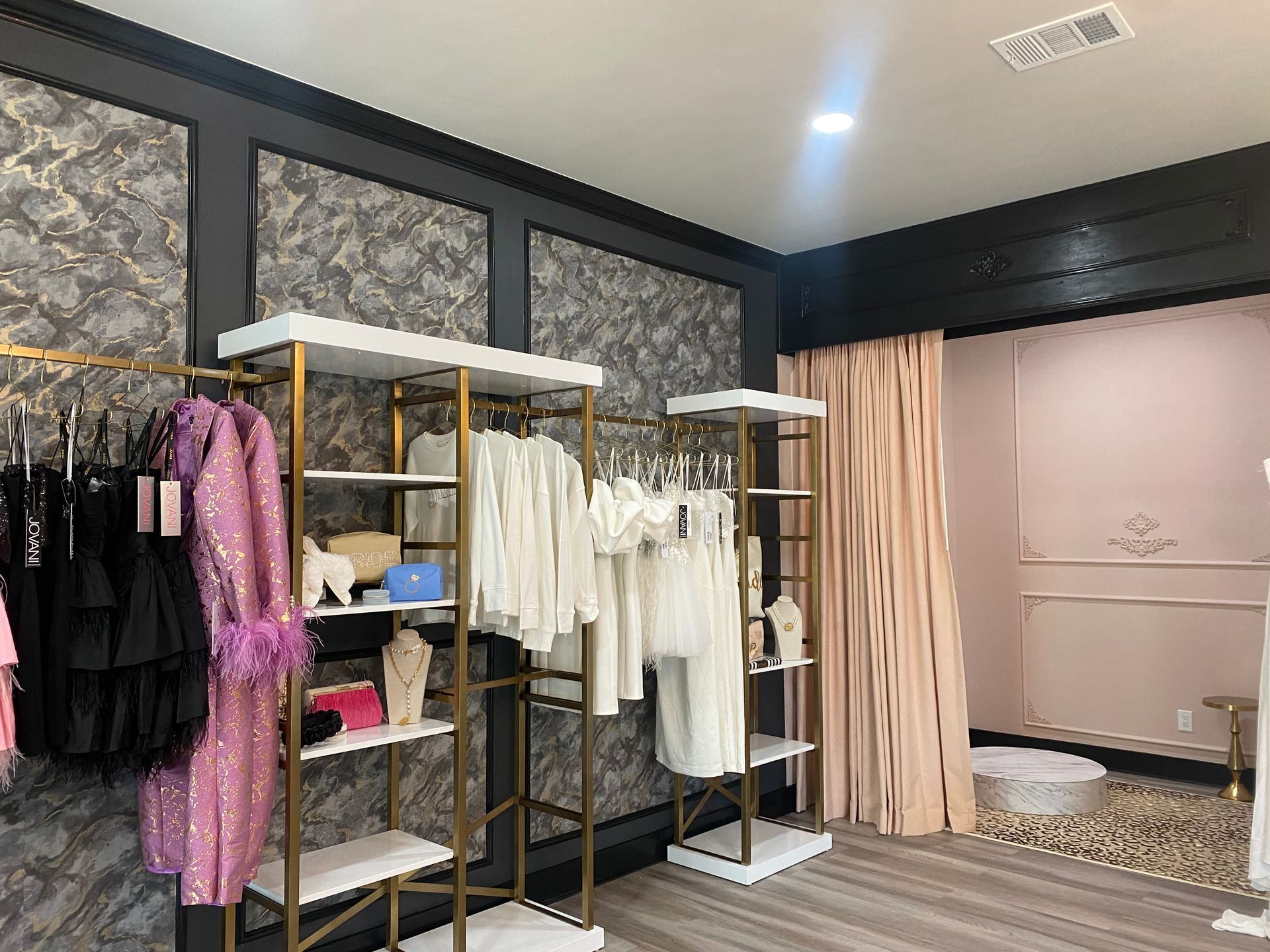 A pink couch is sitting on top of a leopard print rug.