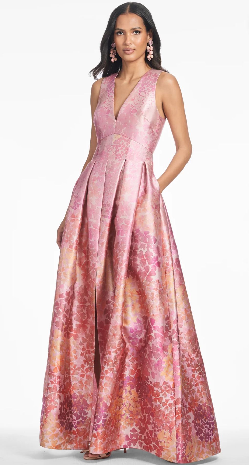 Two women in dresses are standing next to each other in the desert.