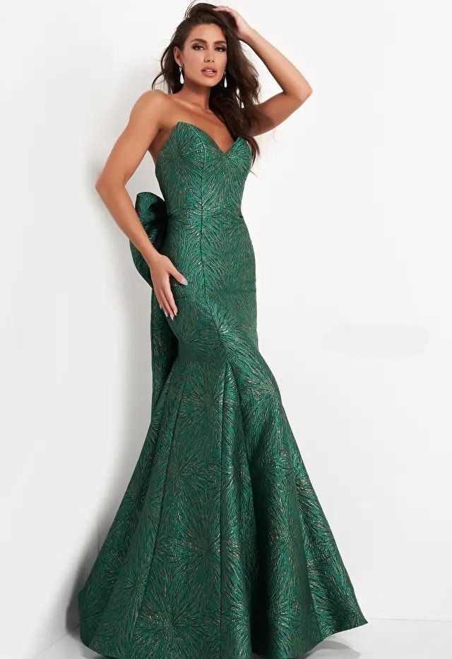 A woman is wearing a green strapless dress by jovani