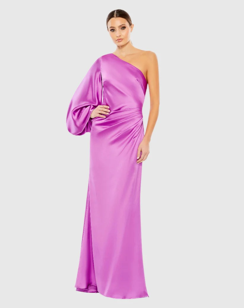 A woman is wearing a purple one shoulder dress.