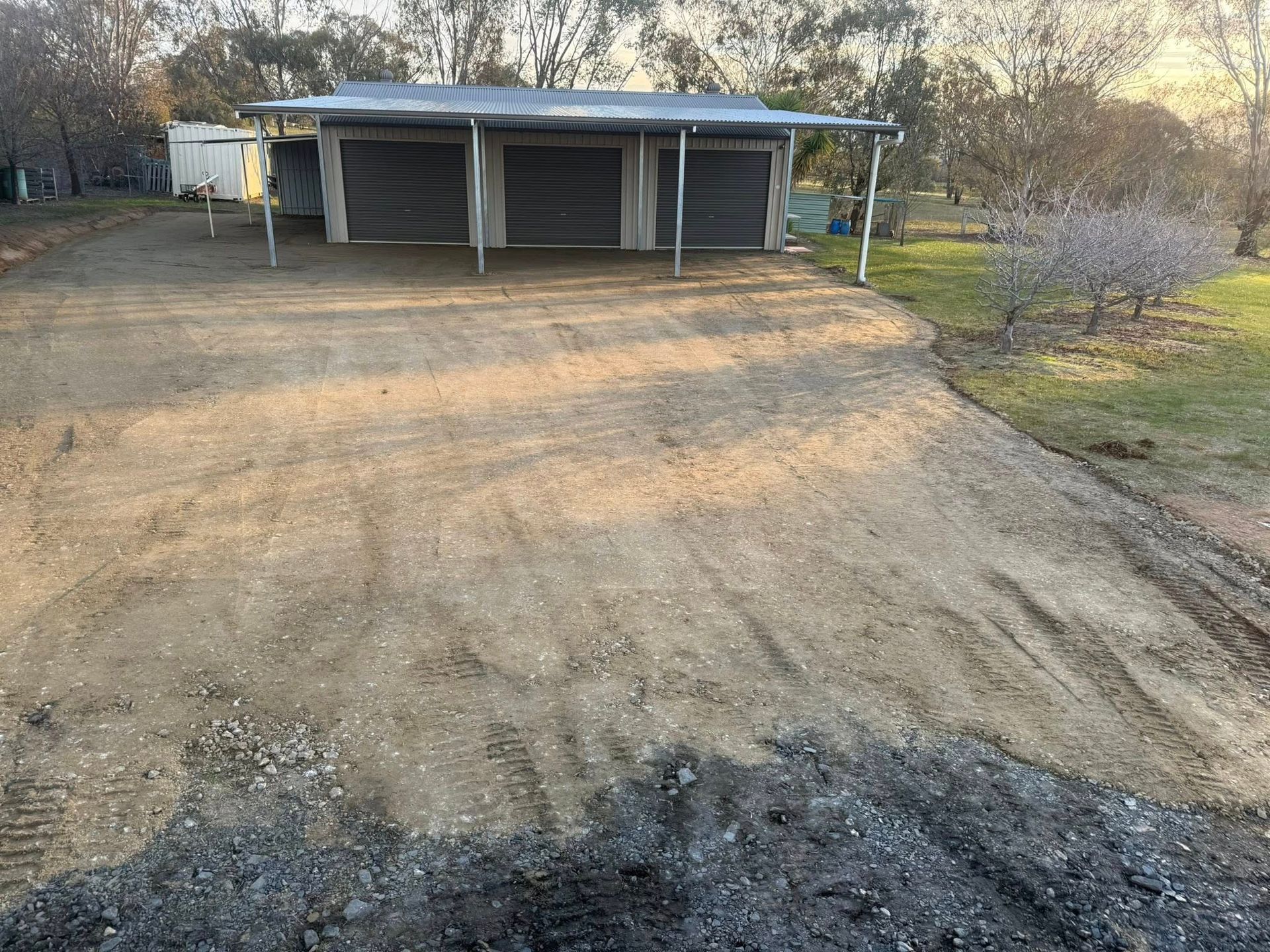 Gravel Driveway Leading to a Carport With Three Bays — Robbo's Hire In Thurgoona, NSW