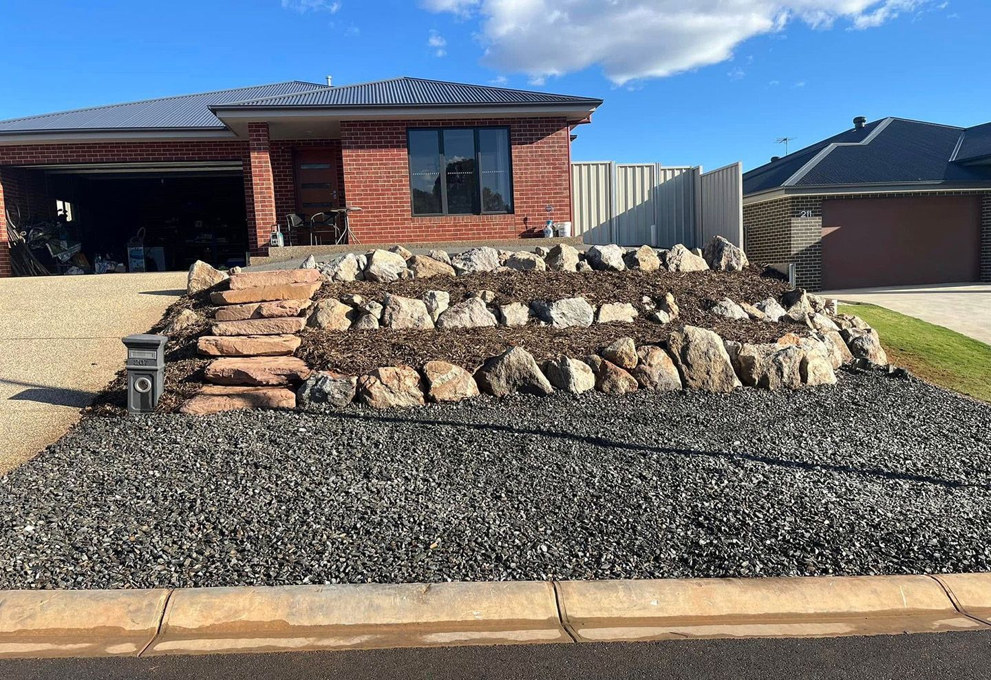 Residential Rock Retaining Wall In Albury — Robbo's Hire In Thurgoona, NSW