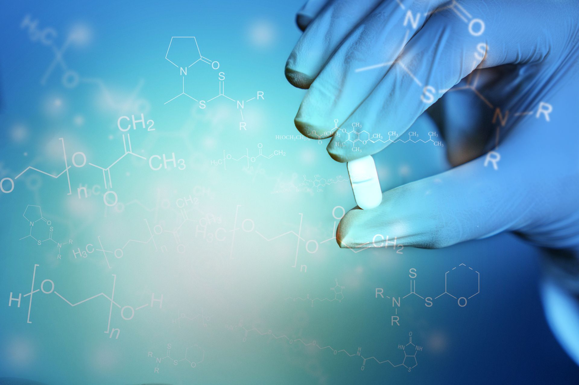 A close up of a person holding a pill in their hand.