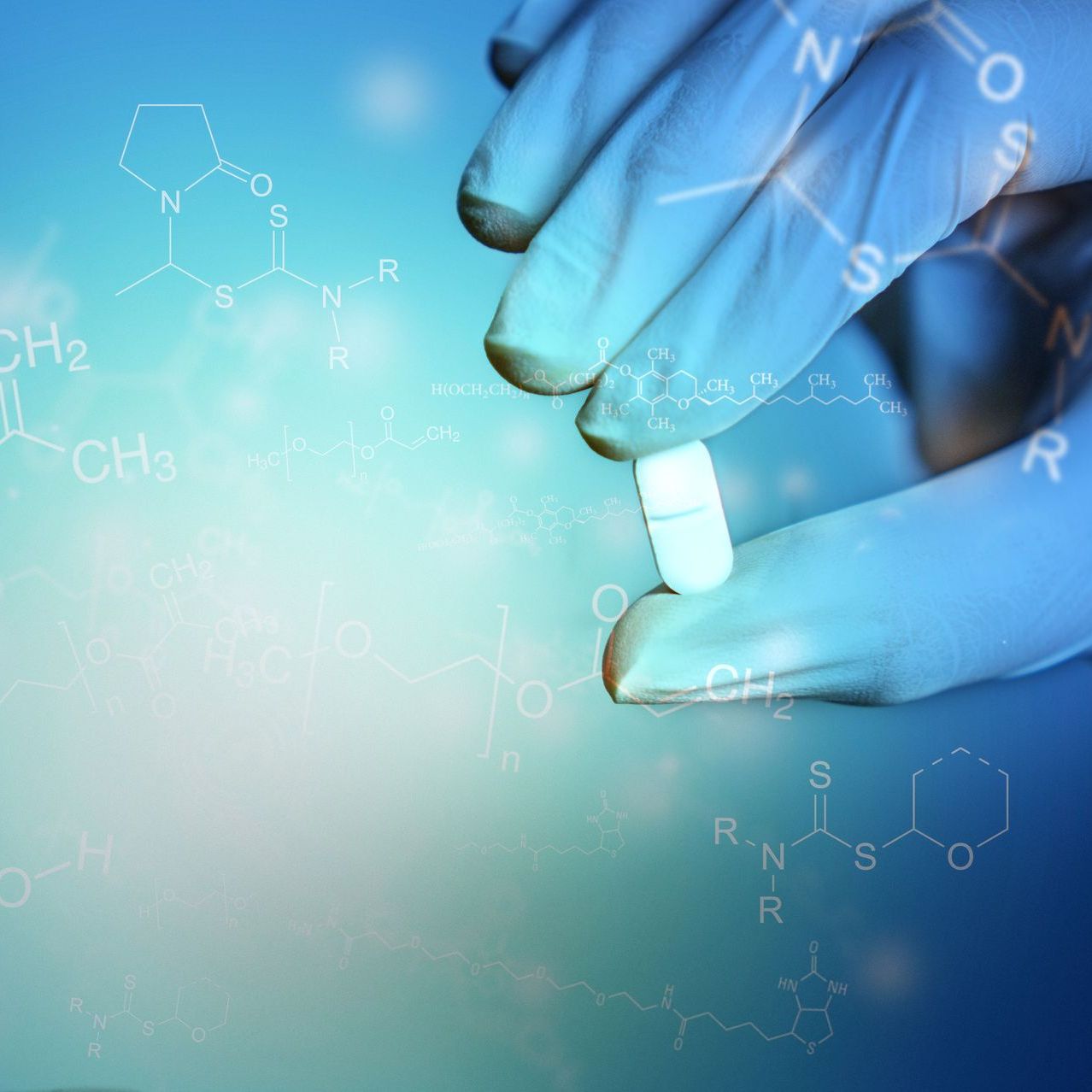A person wearing gloves is holding a pill in their hand.