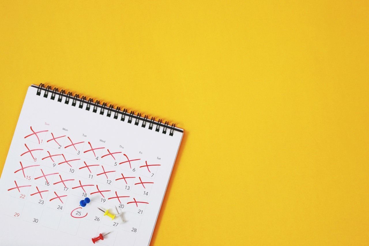 calendar with marked dates on a yellow background