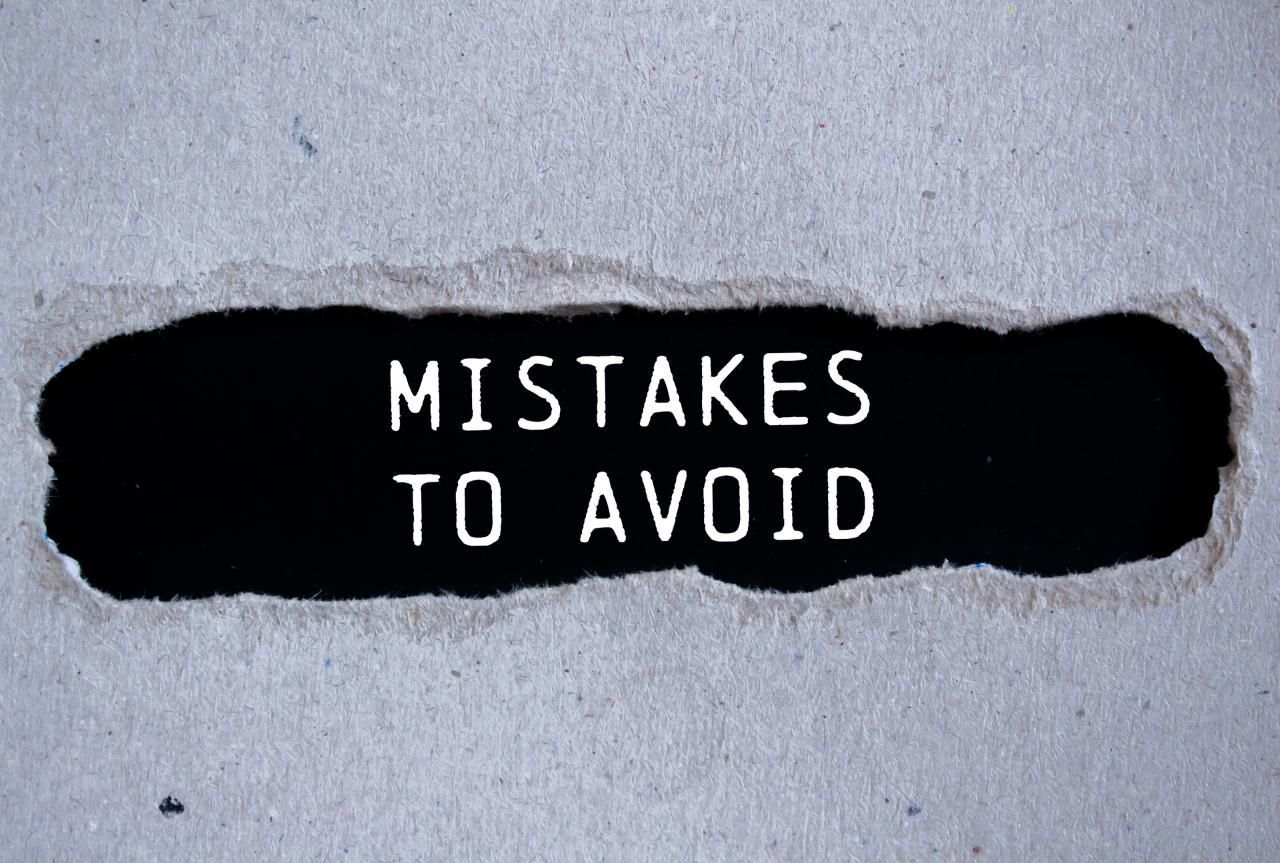 Mistakes to avoid written on ripped torn gray paper with black background