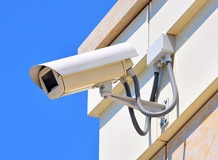A white outdoor CCTV camera