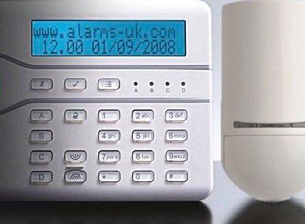 A white access control system with blue display screen