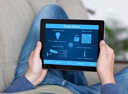 A man in jeans holding an iPad