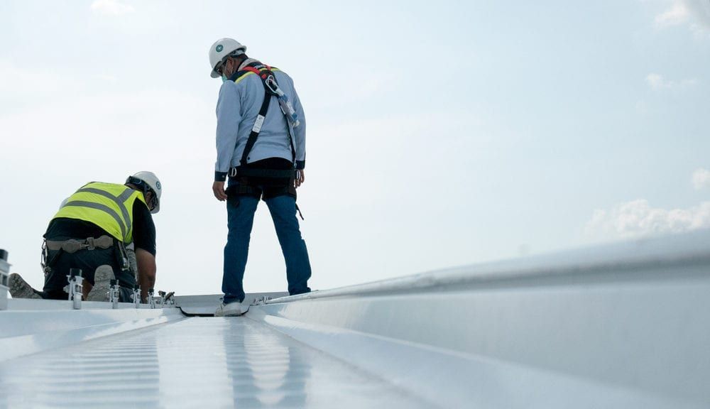 Builder Working On Roof Of New Building — Decatur, AL — Pioneer Roofing Company Inc.