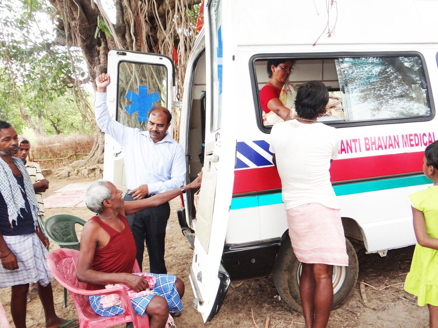 A group of people standing around an ambulance that says anti bhavan medical