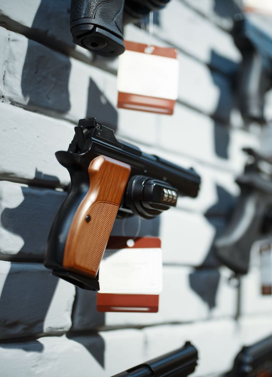 handguns hanging on a wall