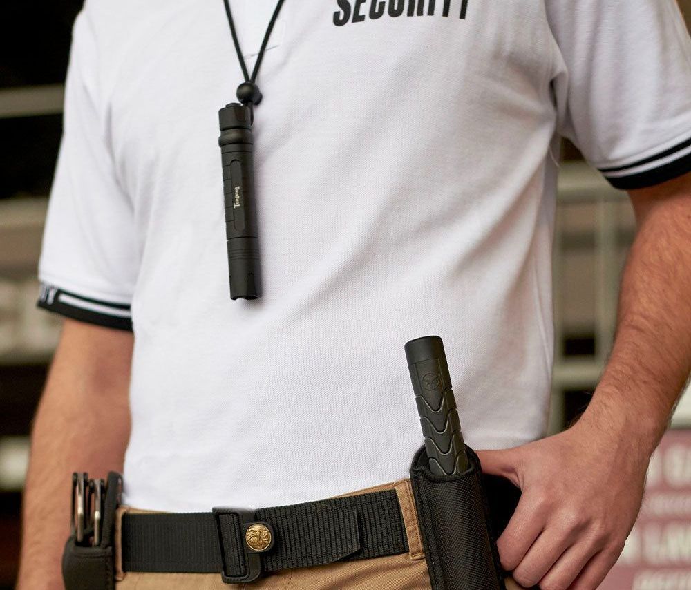 A man wearing a white shirt with the word security on it