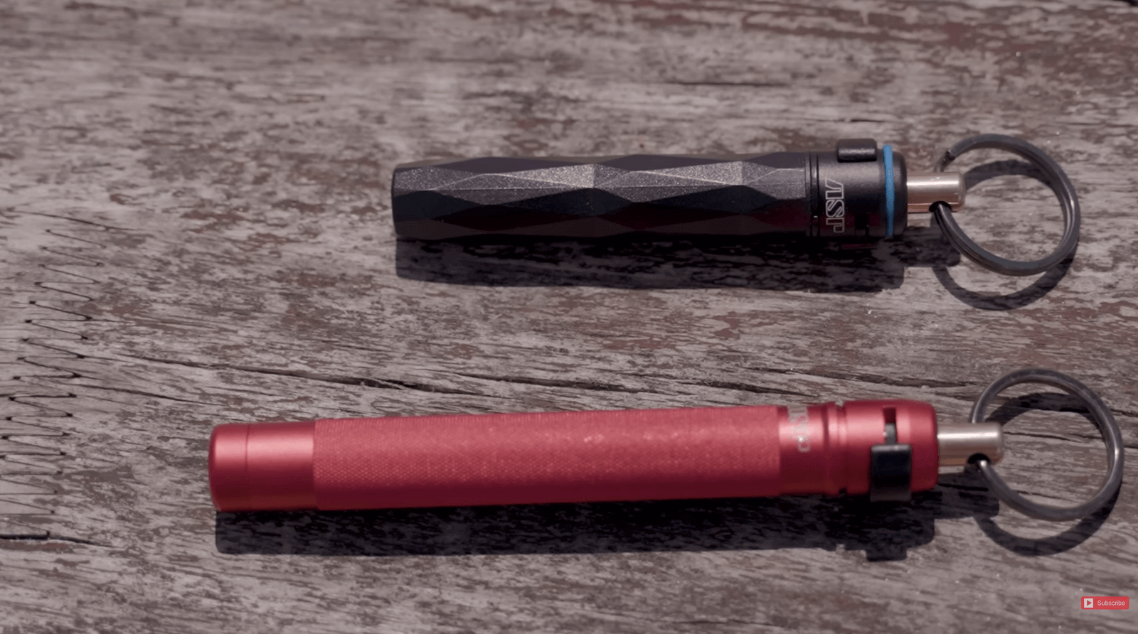 Two pepper sprays are sitting on a wooden table.