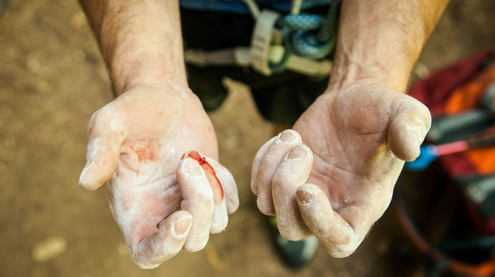 A close up of a person 's hands with chalk on them.